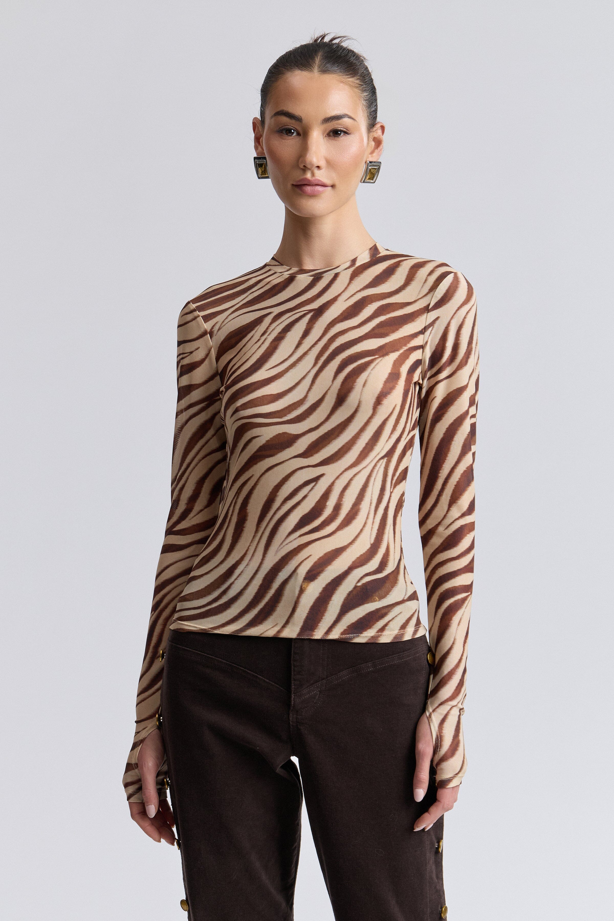 Zebra animal print long sleeve mesh top with humbhole sleeves. Shop women's cute printed tops by Avec Les Filles