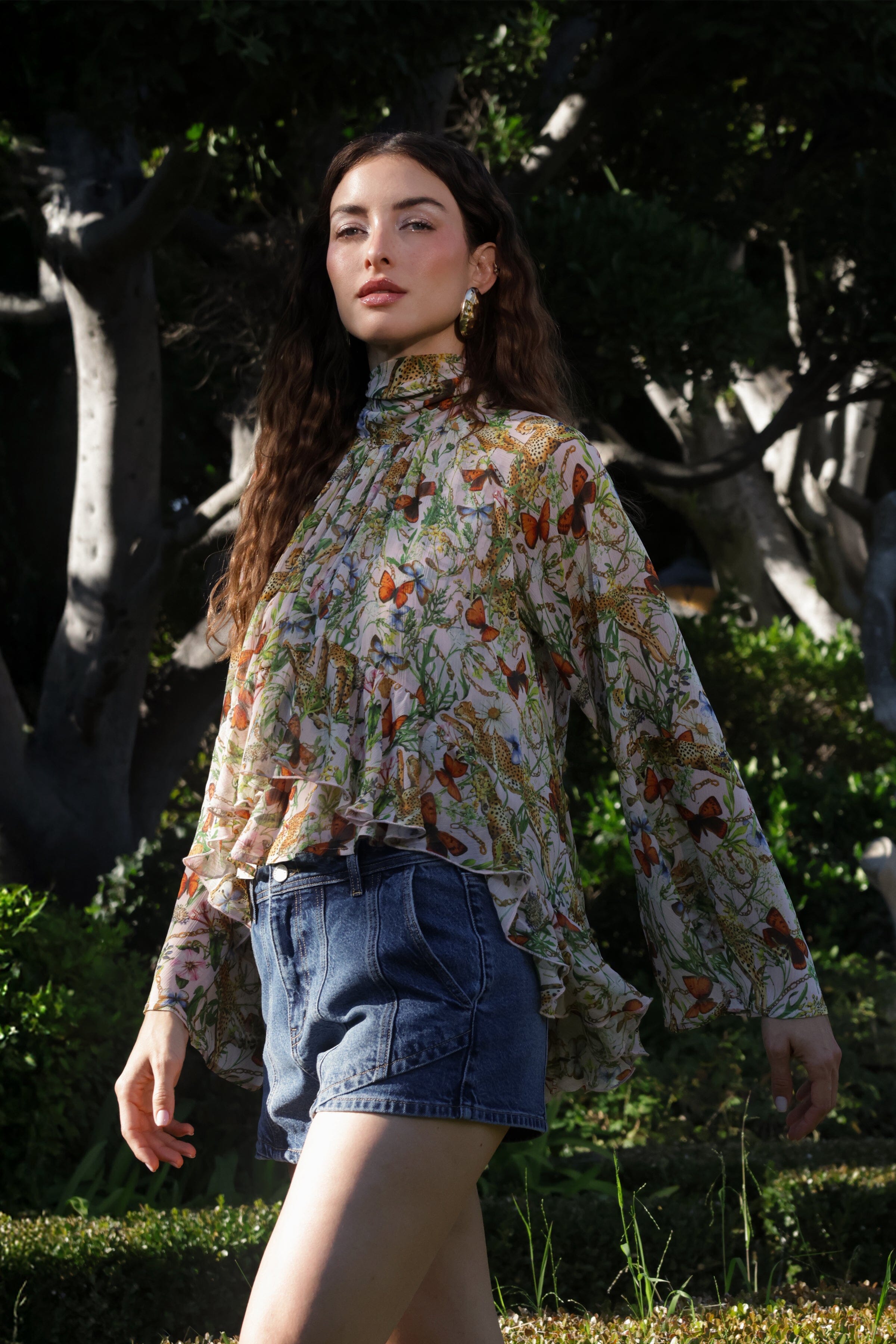 Botanical pink cheetah print chiffon ruffle blouse top with dark blue high-rise denim shorts by Avec Les Filles