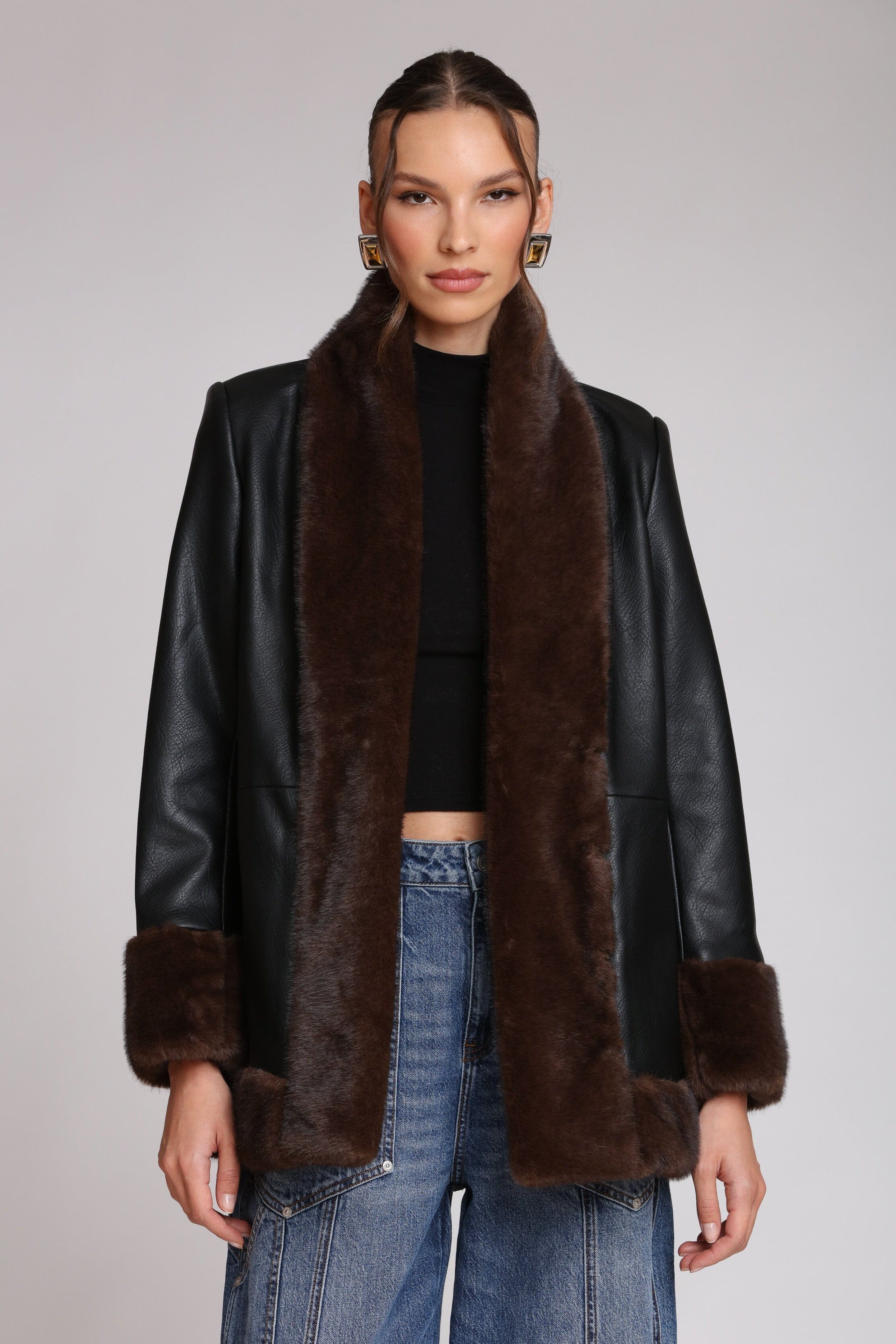 Brown fur-trimmed faux leather black jacket with open-front design, hook-and-eye closure, and side welt pockets - Shop designer women’s jackets by Avec Les Filles
