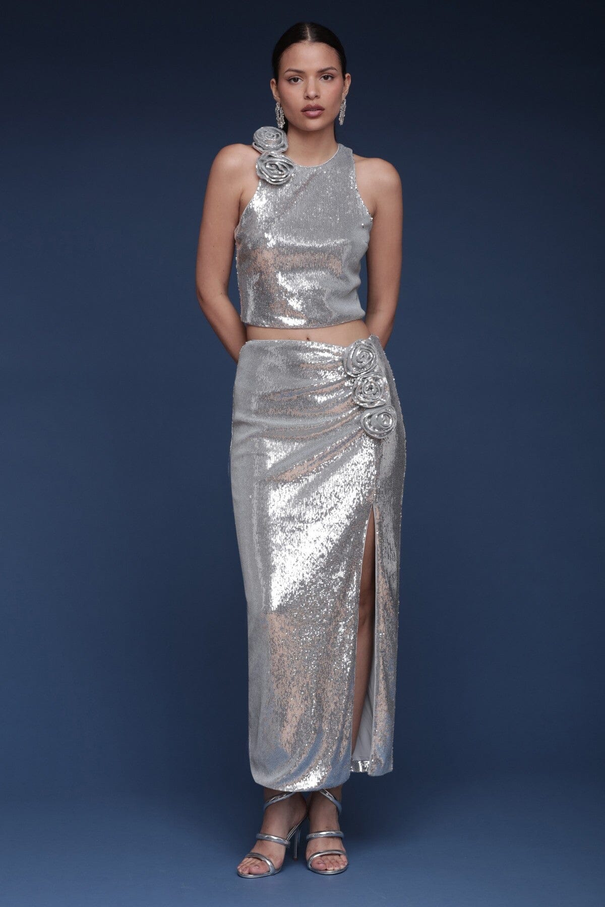 Rosette embellished sequin silver crop top with a halter neckline, sleeveless and button closure - Shop designer women's party tops by Avec Les Filles