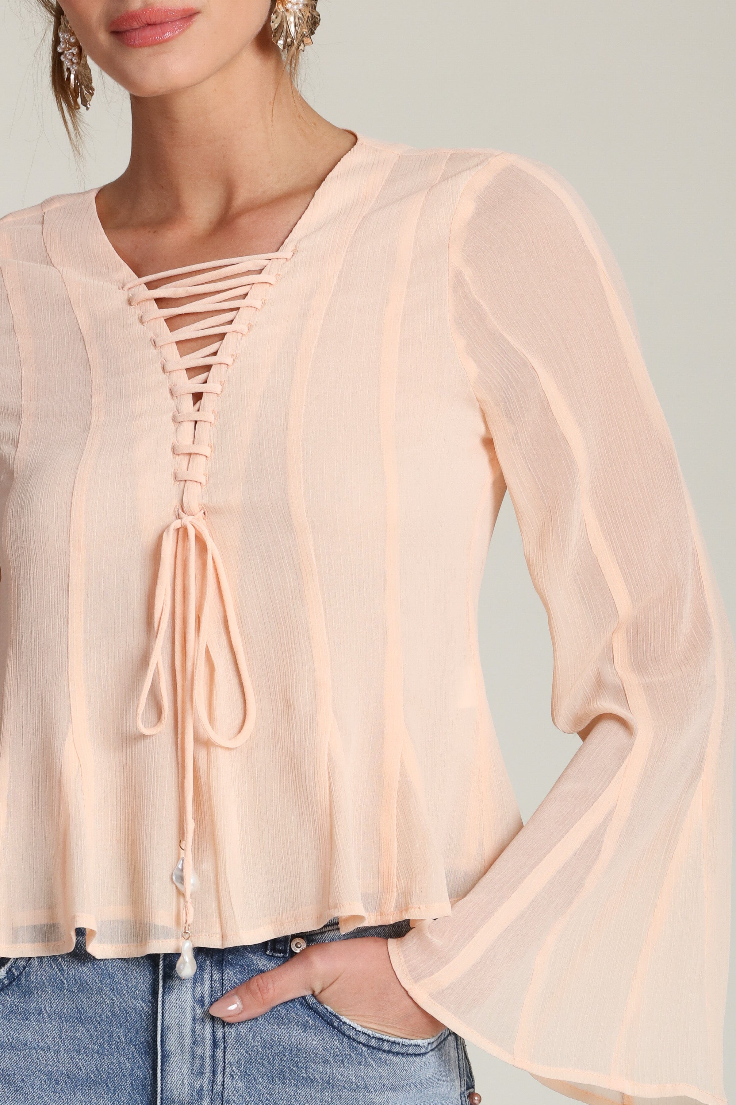 Lace-up peplum chiffon peach blouse with a V-neckline and long flared sleeves - Shop designer women’s chiffon blouses by Avec Les Filles