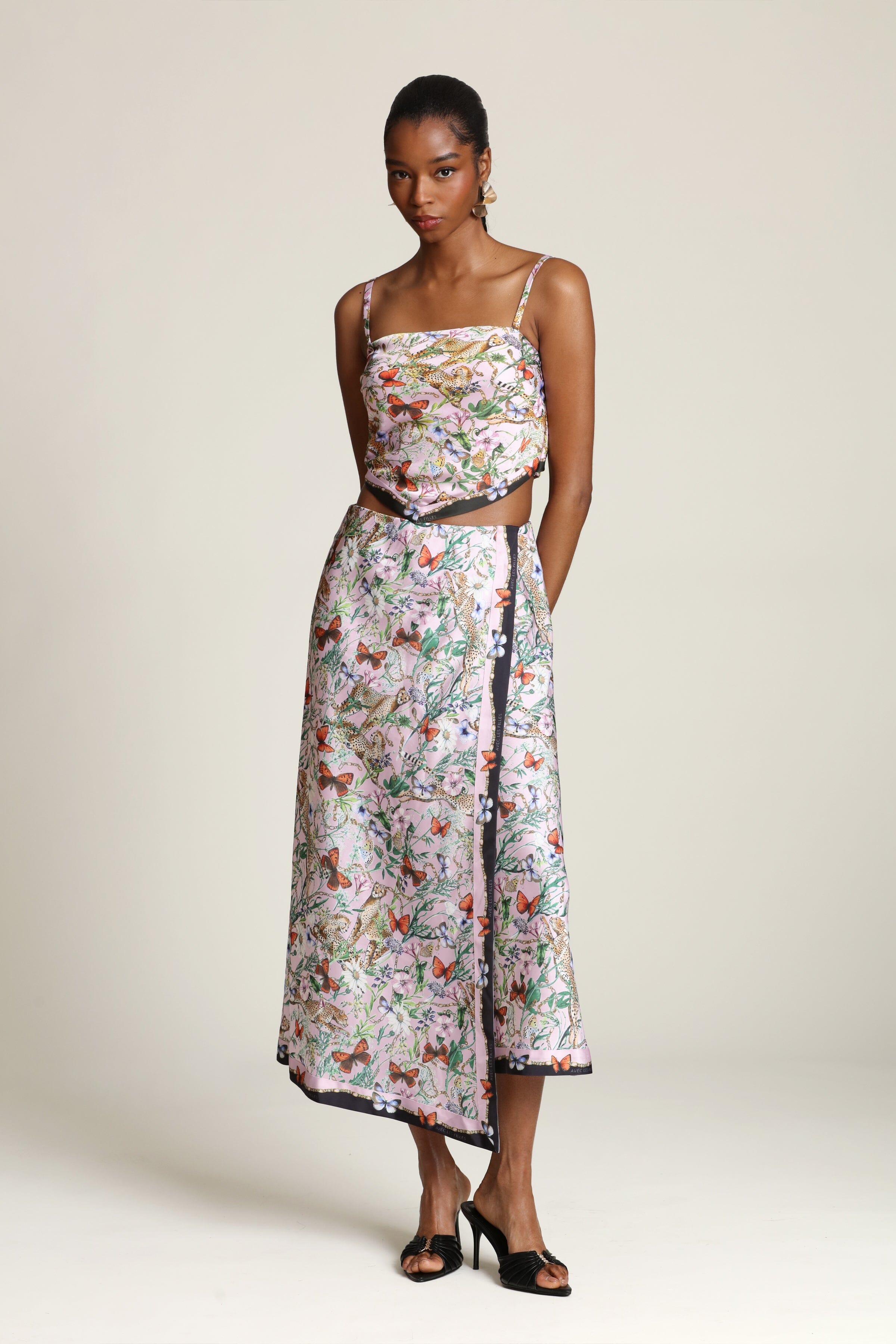 Botanical satin pink cheetah printed faux wrap maxi slip skirt with an elastic waistband and printed pink crop top by Avec Les Filles