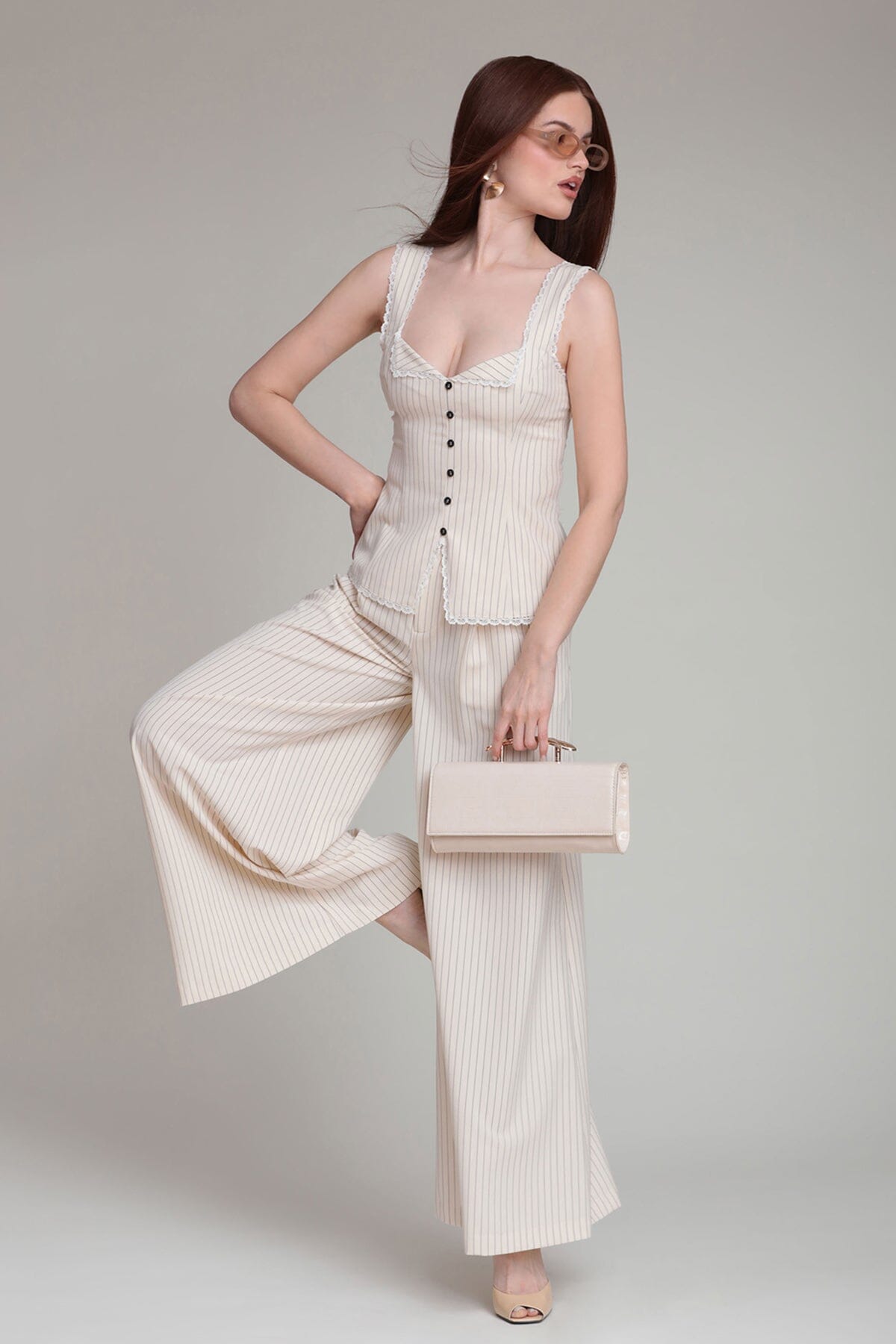 Stripe suiting wide leg pant with high-rise waist and cream and black striped button up tank top by Avec Les Filles