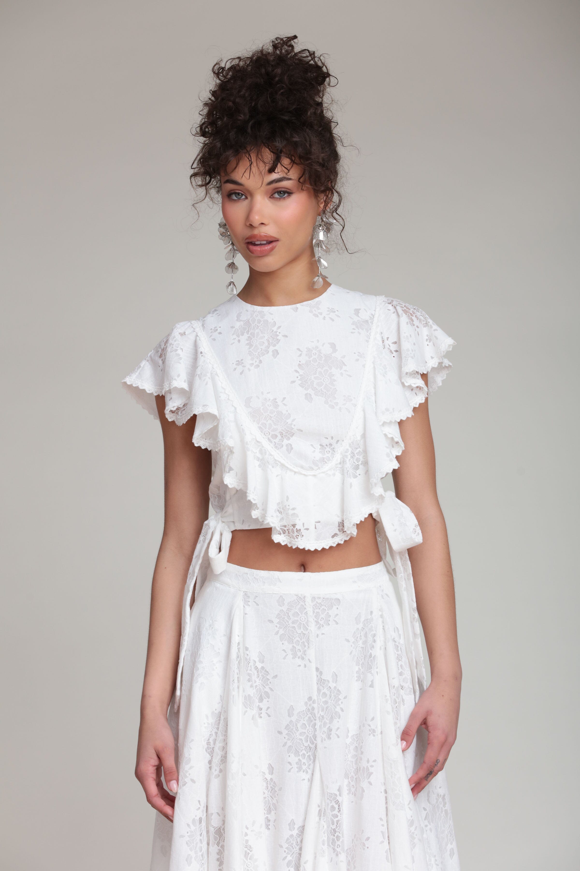 Ruffle white crop top with adjustable ties and flutter sleeves. Shop women's cute crop tops by Avec Les Filles