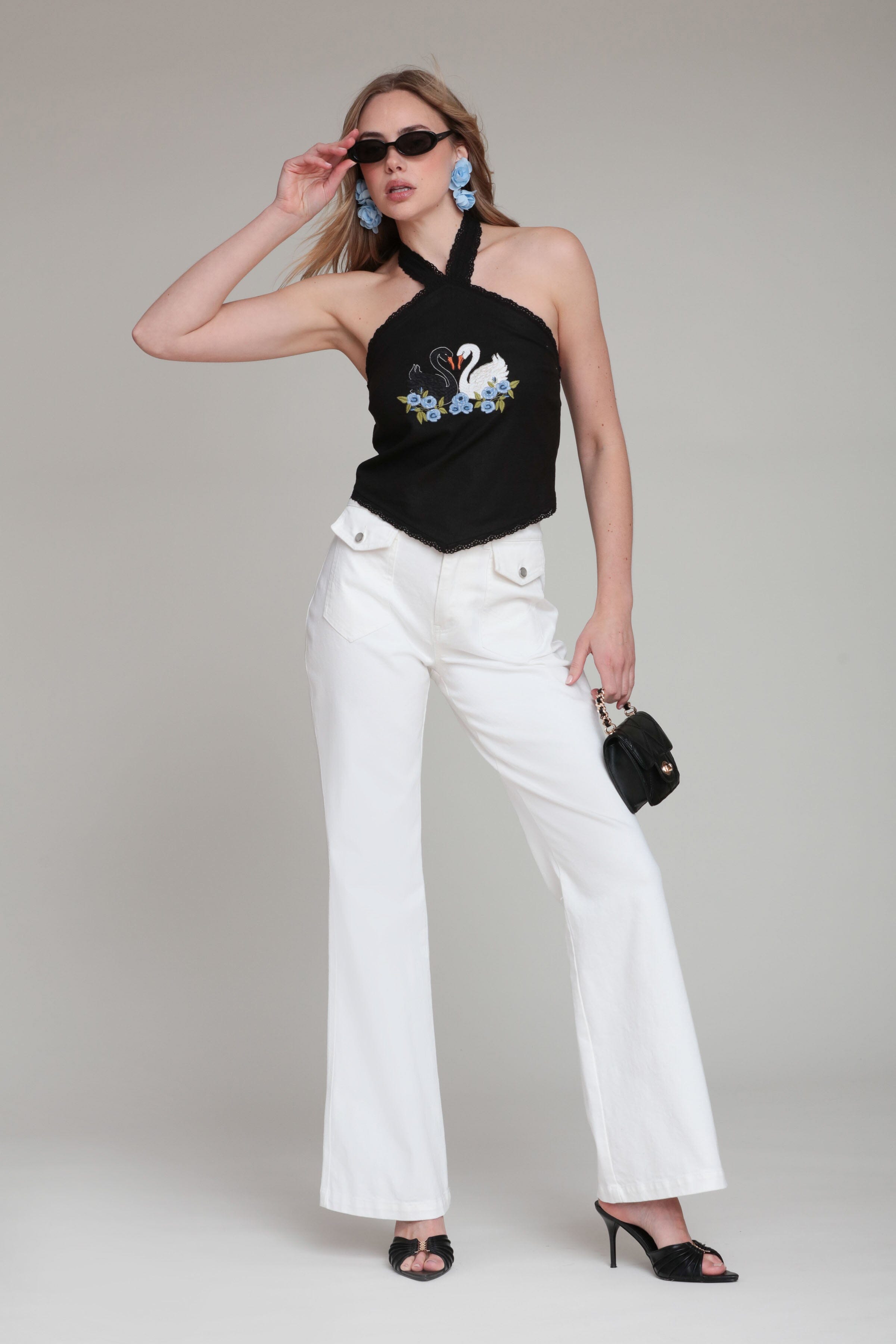 Denim white flared jeans in cotton blend with black halter neck top - Shop women's high waisted flare jeans by Avec Les Filles