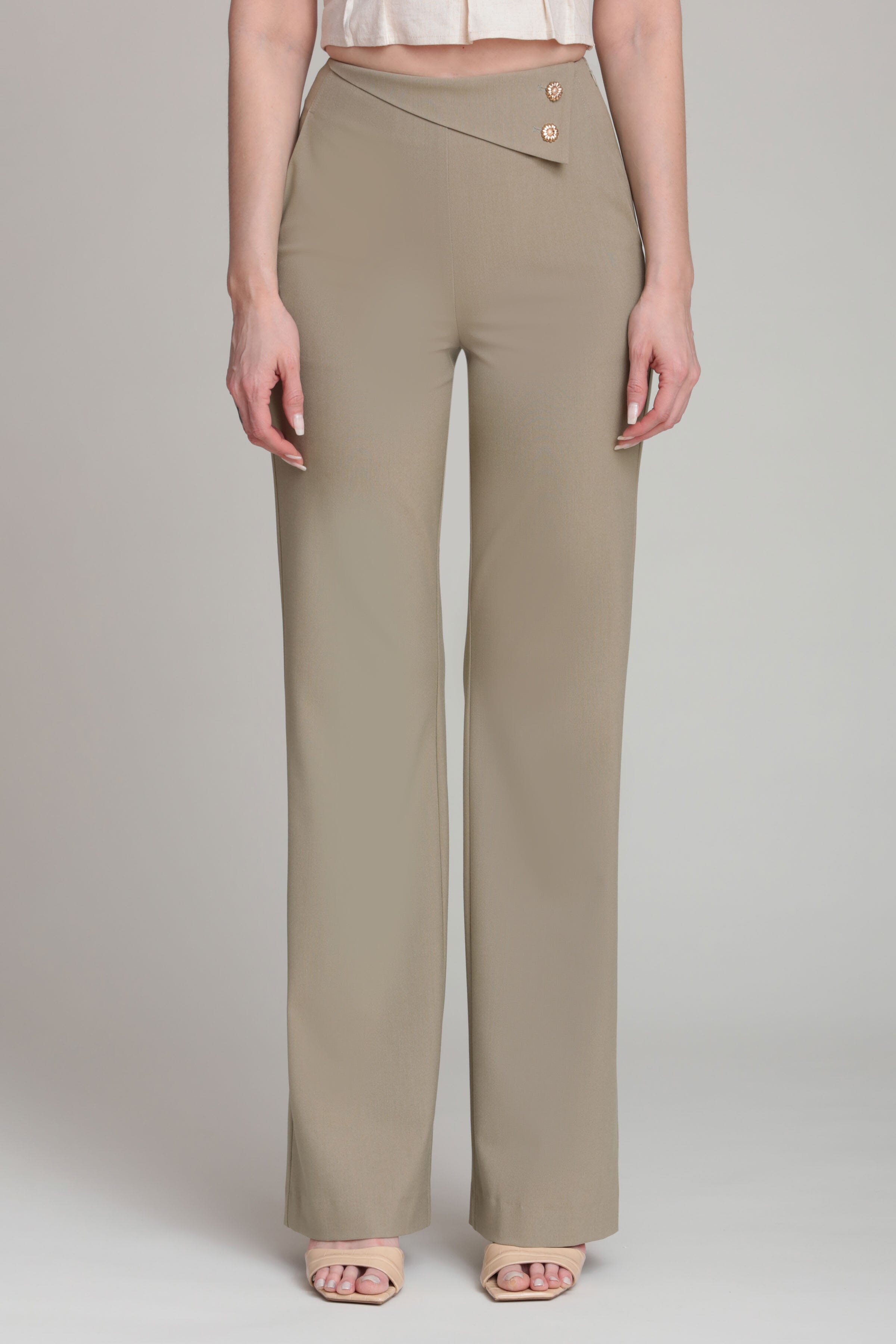 Asymmetric waist-tailored beige trousers with a high-rise waist and decorative button by Avec Les Filles
