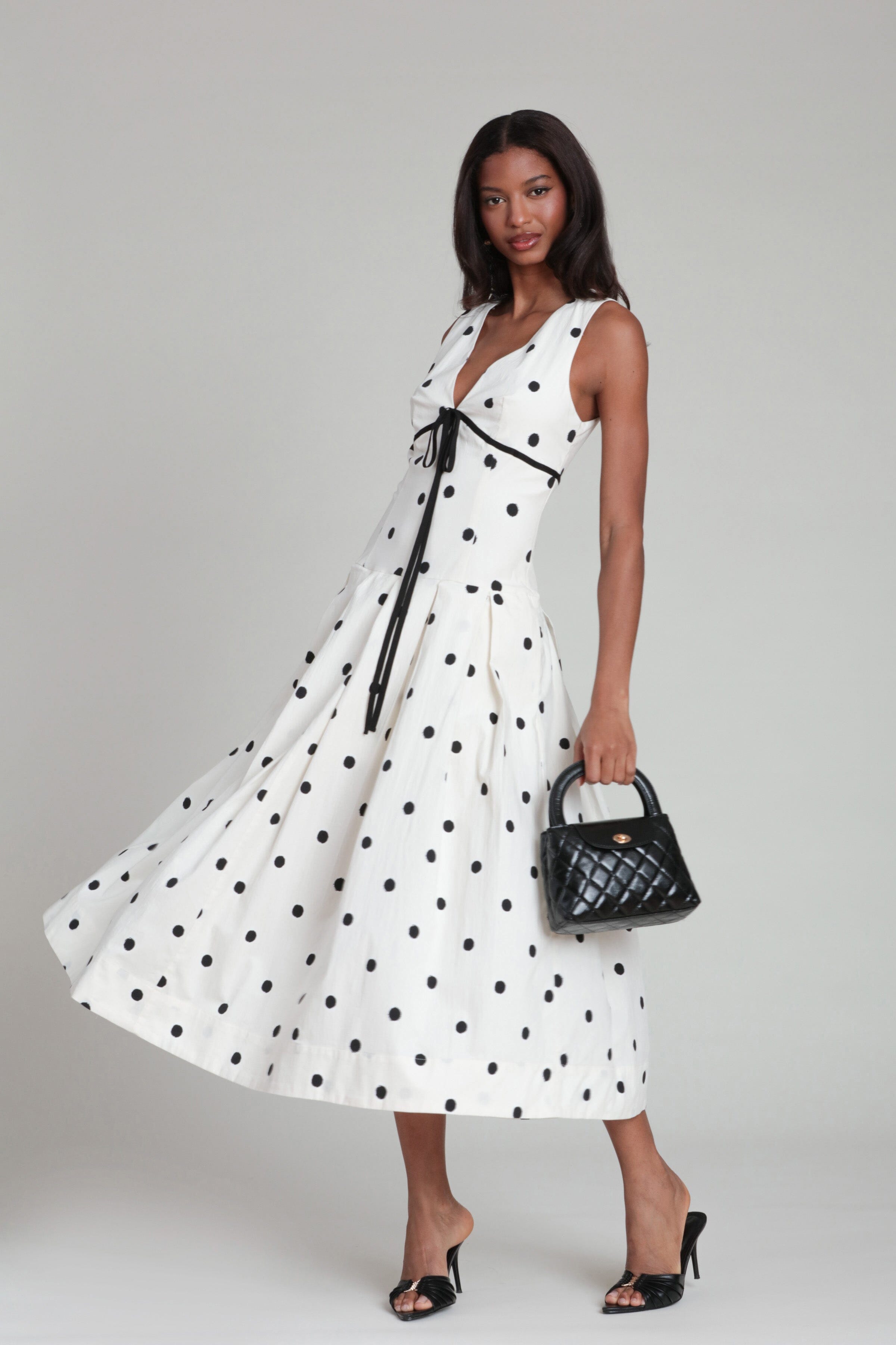 Sleeveless black and white polka dot dress with V-neck and pleat skirt - Shop cute midi dresses by Avec Les Filles