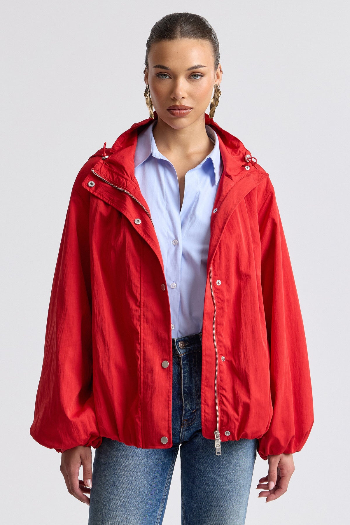 Nylon-blend hooded windbreaker red jacket with balloon sleeves. Shop women's red jackets by Avec Les Filles.