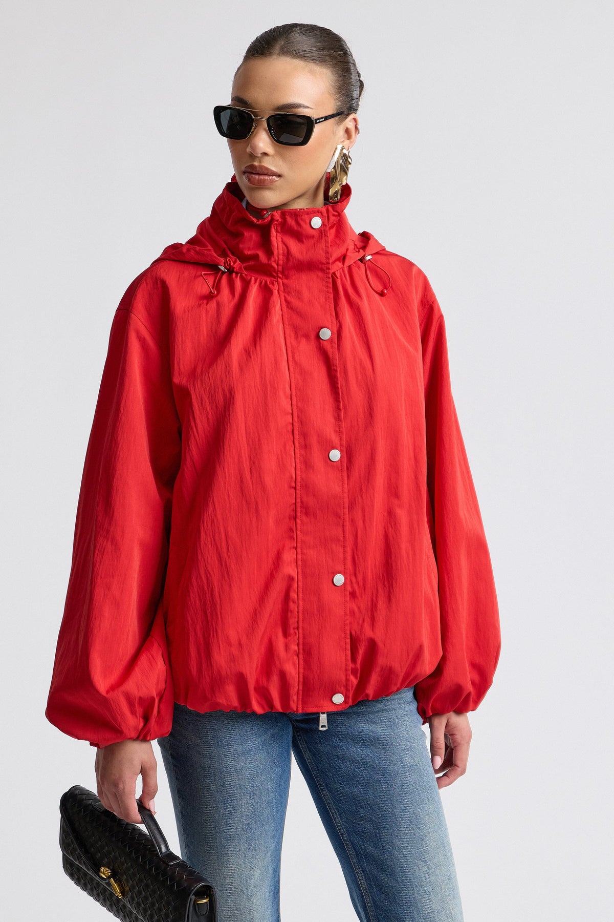 Nylon-blend hooded women windbreaker red jacket with balloon sleeves. Shop designer red jackets by Avec Les Filles.