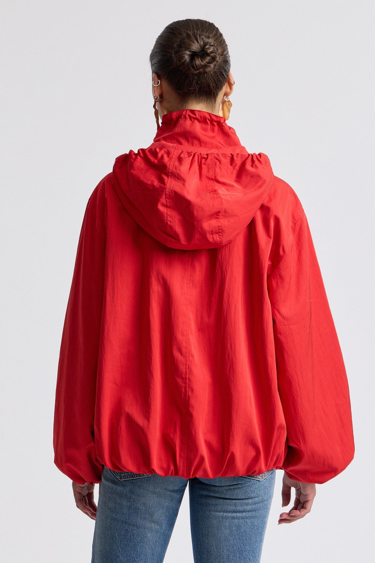Nylon-blend hooded windbreaker womens red jacket with balloon sleeves. Shop cute red jackets by Avec Les Filles.