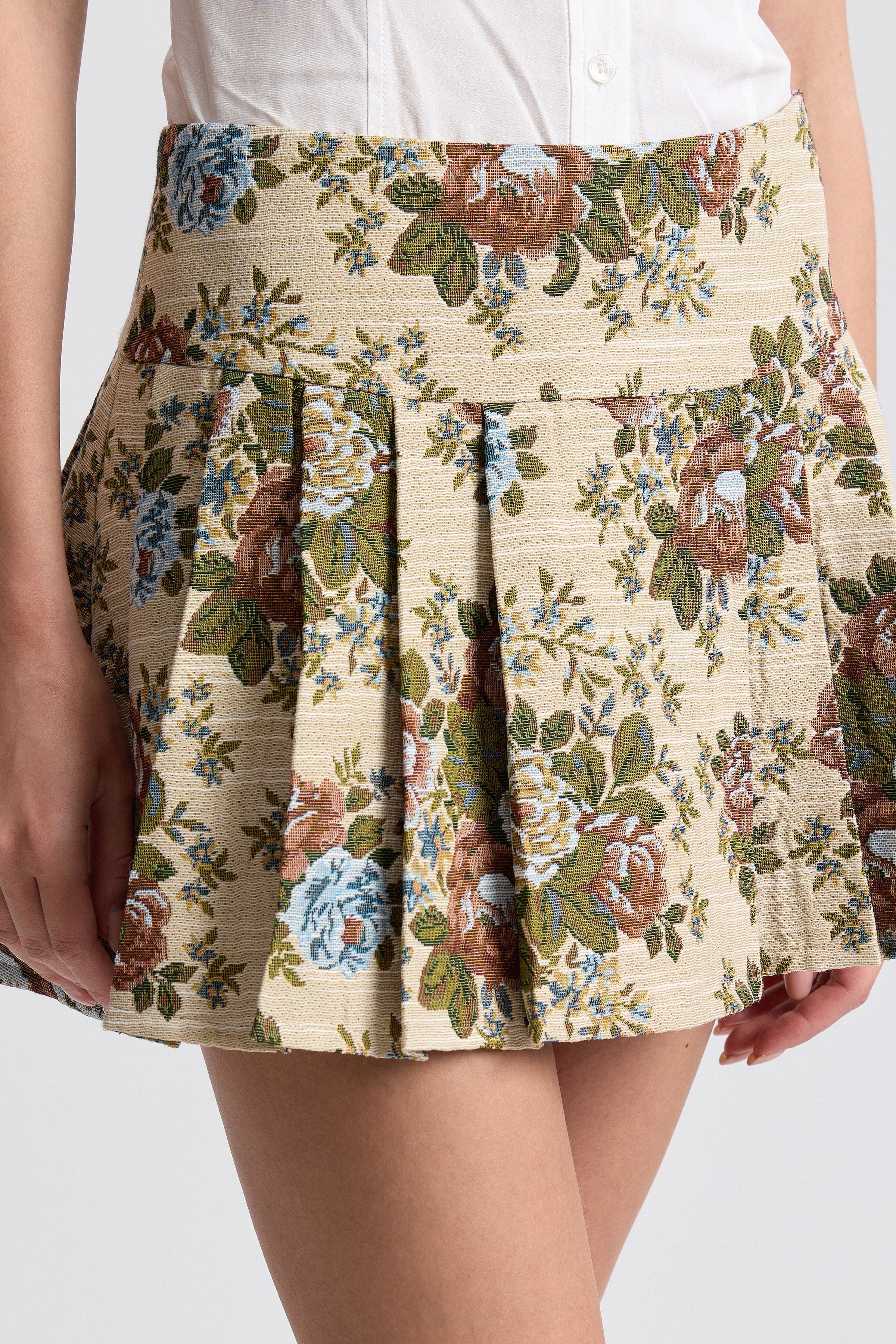 Taupe floral brocade mini skirt with knife-pleated design. Shop designer women's cute mini skirts by Avec Les Filles.