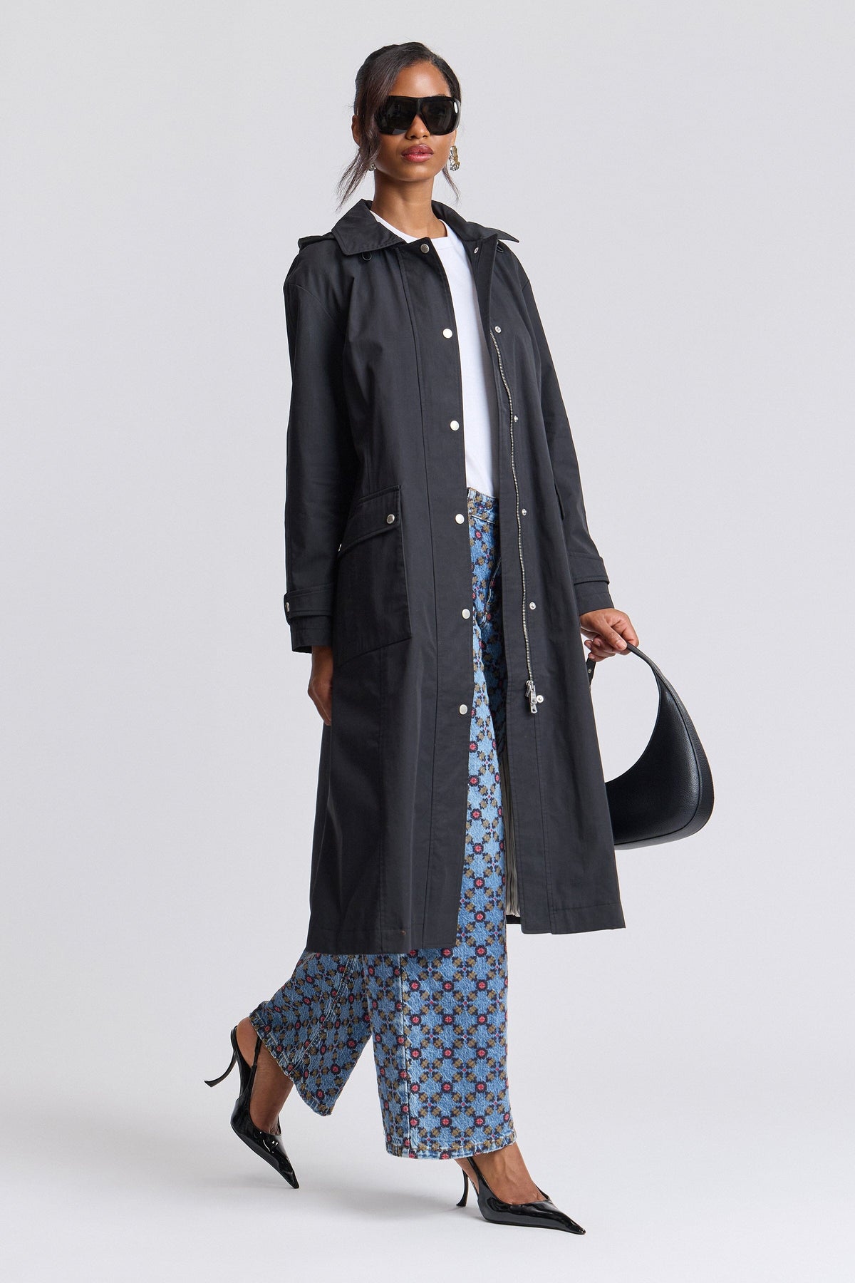 Long black rain coat anorak with long sleeves and a snap-front - Shop women's long coats by Avec Les Filles.