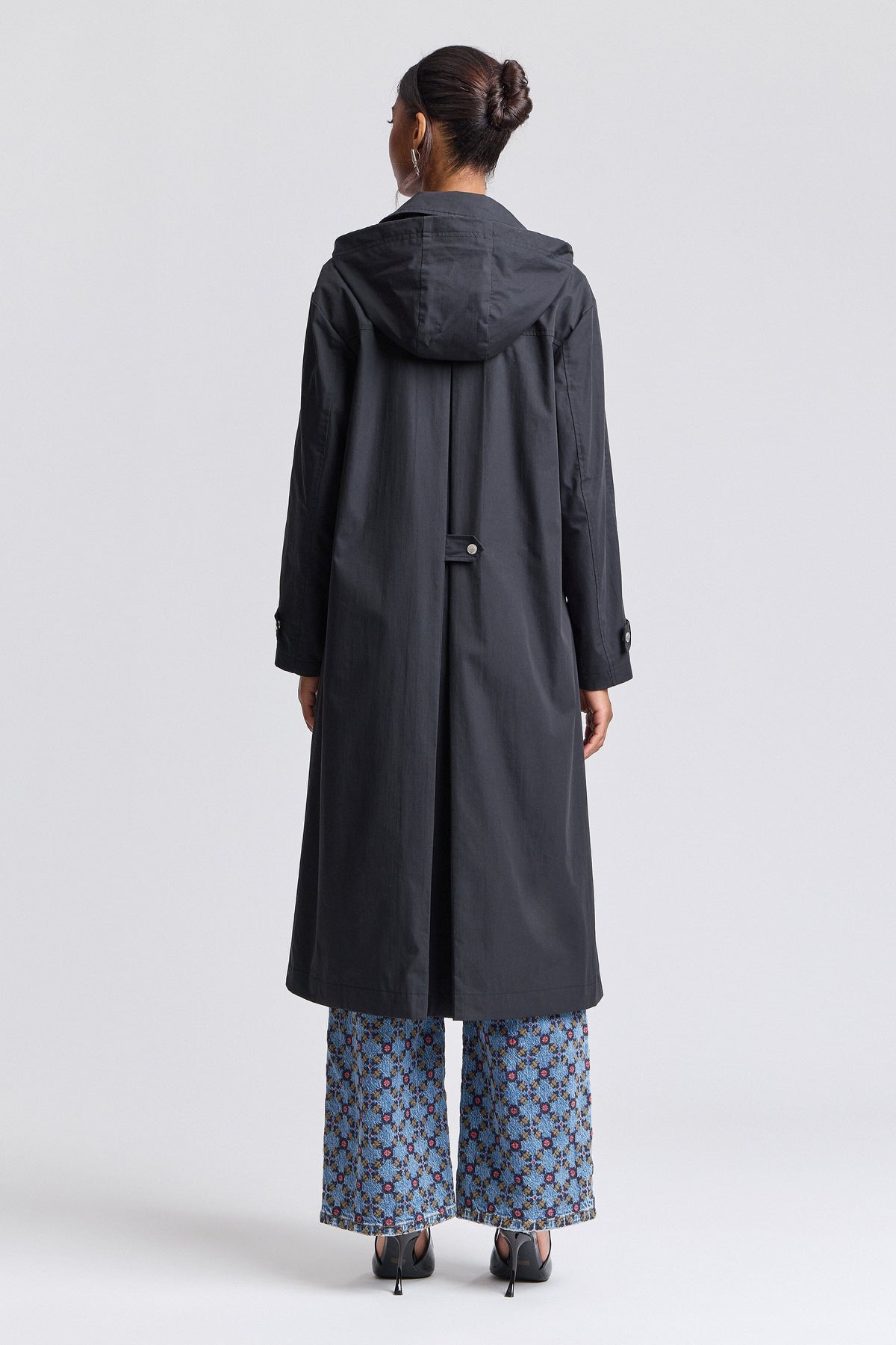 Womens long black raincoat with an adjustable hood and long sleeves - Shop designer long coats by Avec Les Filles.