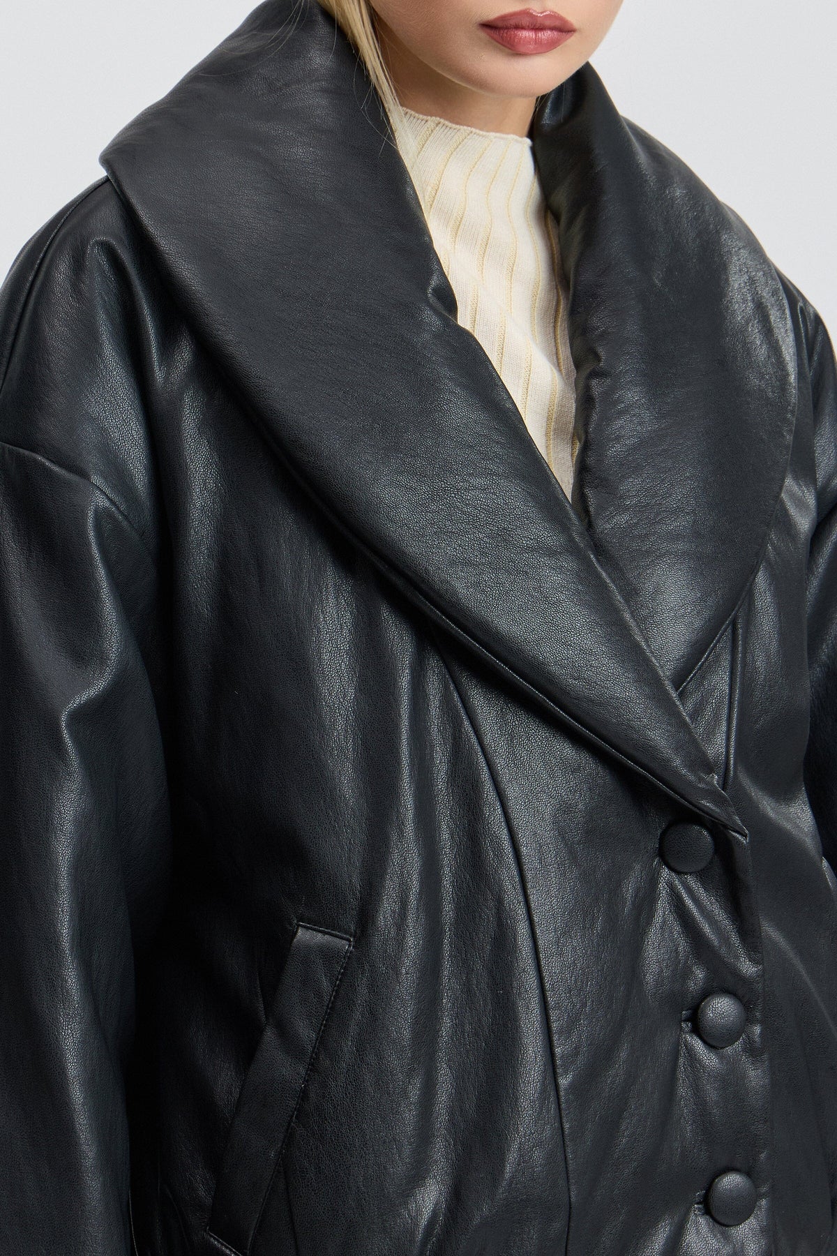 Faux leather black puffer jacket with an oversized shawl collar and button front. Shop women's jackets by Avec Les Filles.