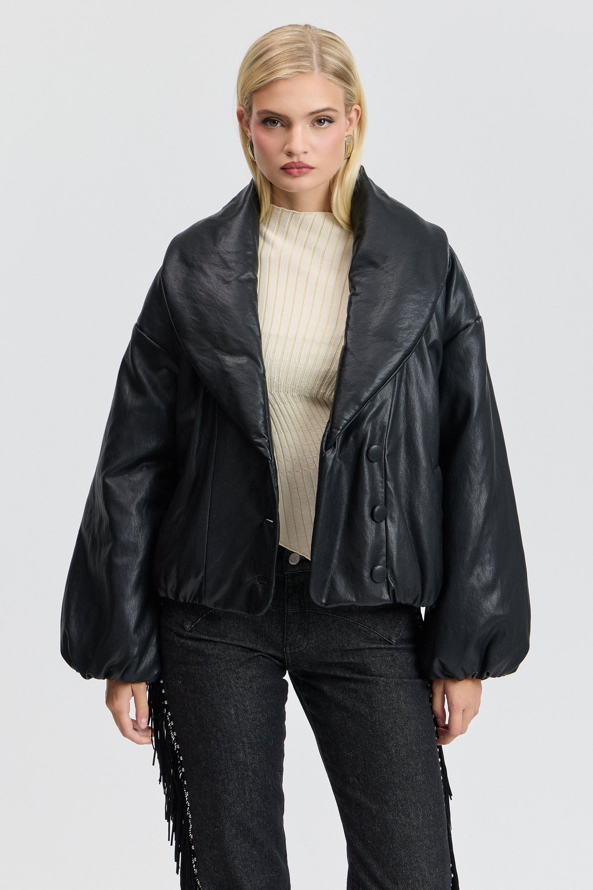 Faux leather black puffer jacket with an oversized collar and button front. Shop black puffer jackets by Avec Les Filles.