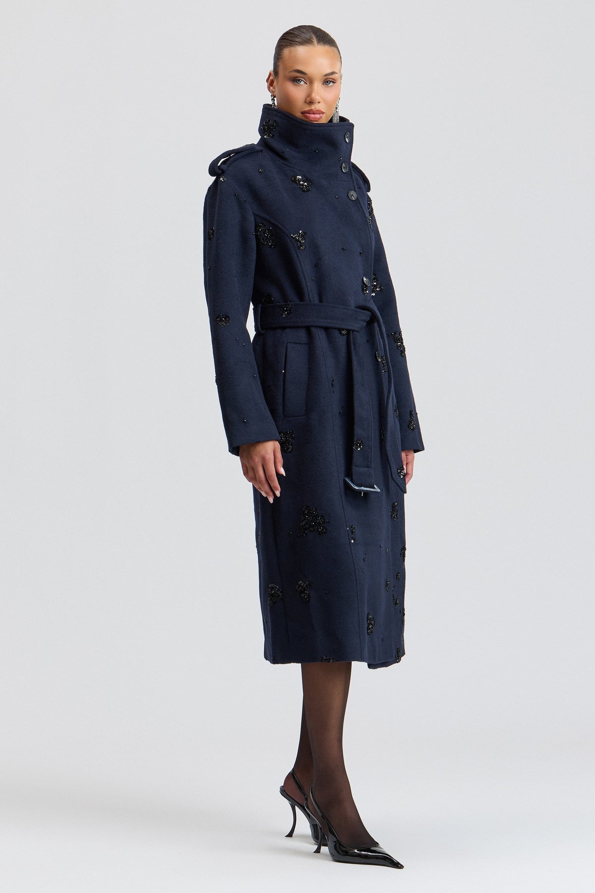 Sequin-embellished navy long trench coat women with funnel collar and a belt. Shop designer coats by Avec Les Filles.