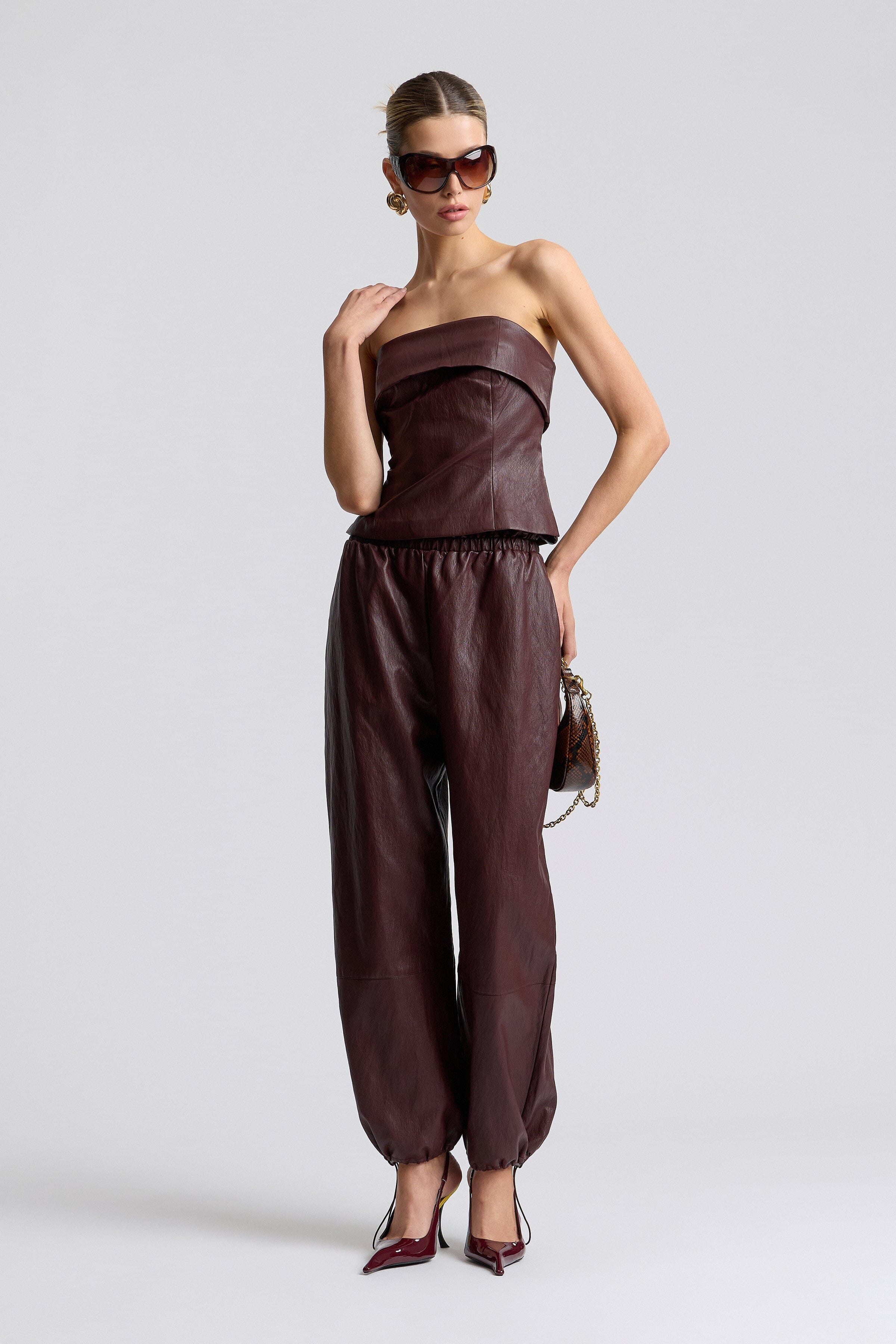 Brown faux leather joggers with an elastic waist and fitted tube top. Shop women's tops & joggers by Avec Les Filles.