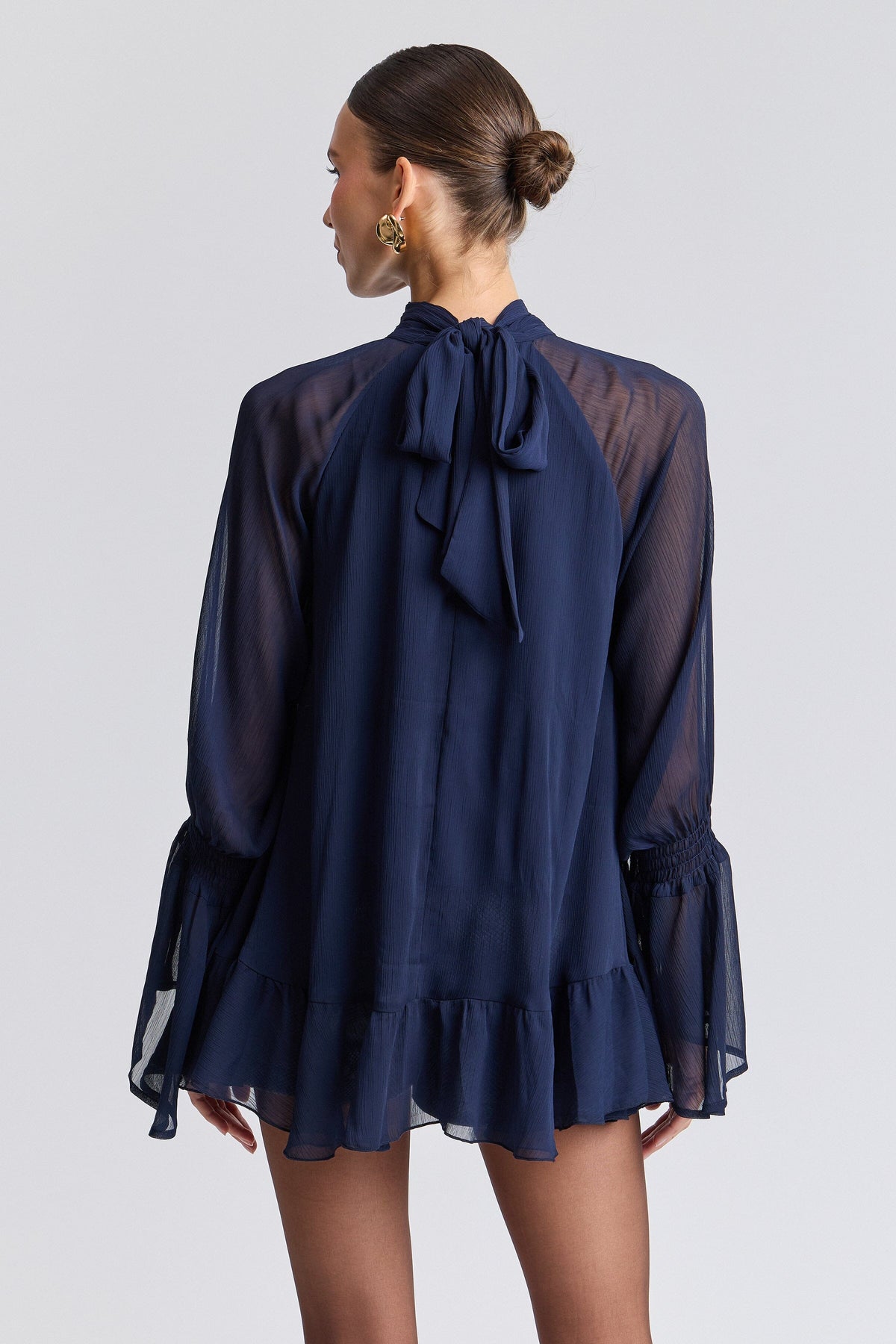 Ruffle tie-neck navy long sleeve flowy top and a high-low layered hem - Shop cute navy blue tops by Avec Les Filles.
