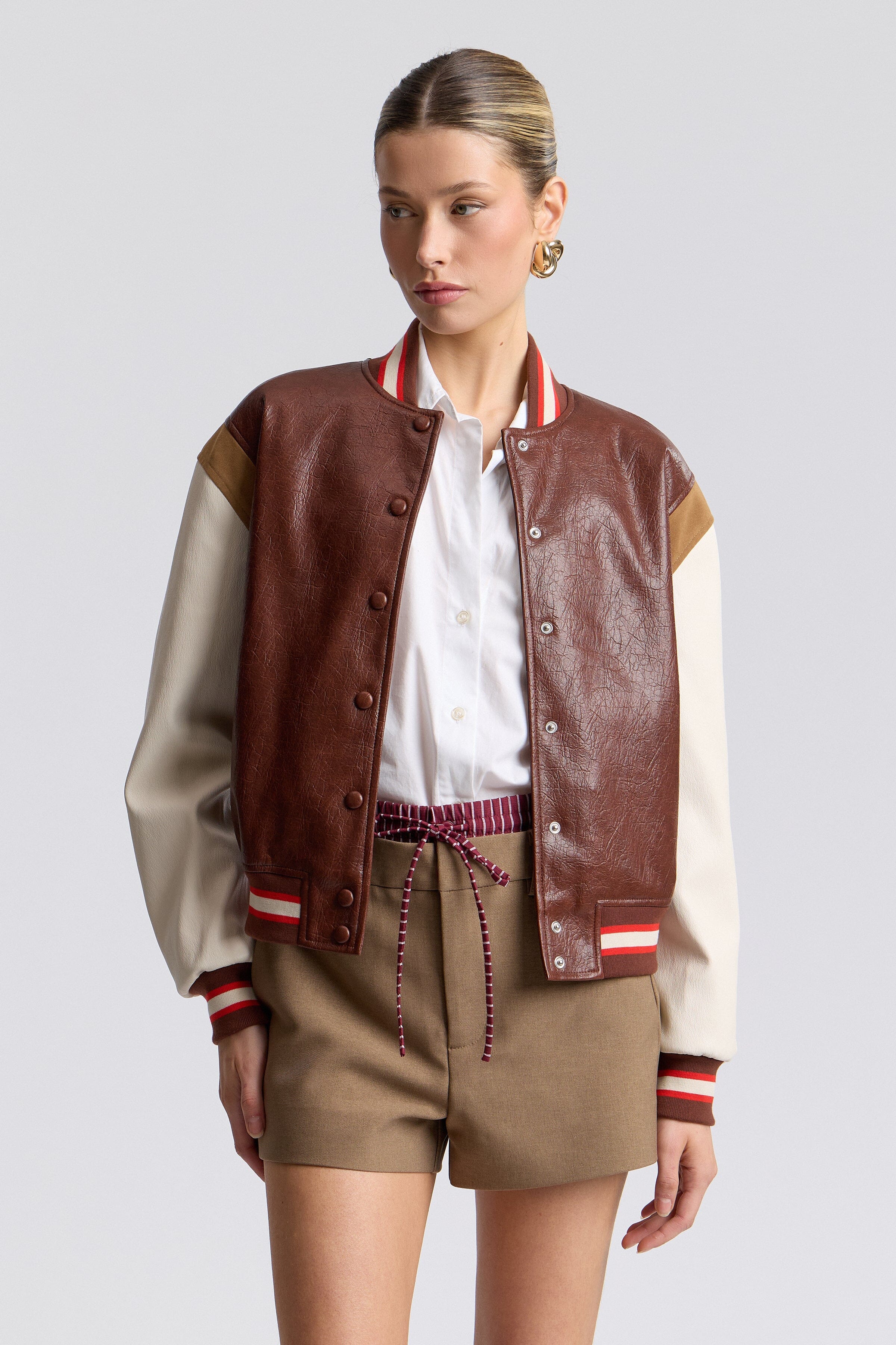 Faux-leather red varsity jacket with a snap-button front and long sleeves - Shop cute varsity jackets by Avec Les Filles.