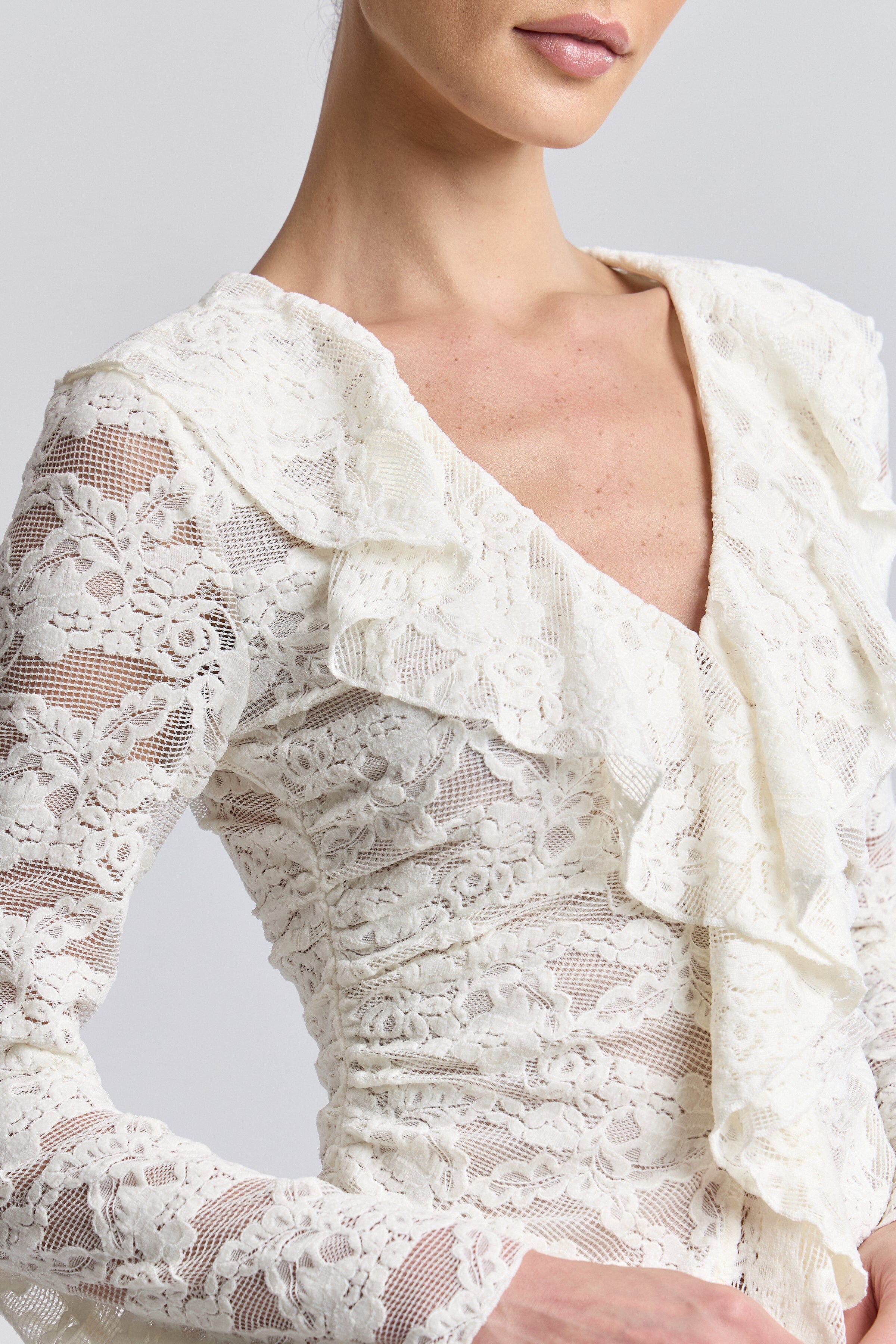 Ruffle front off white lace top with deep V-neckline and long sleeves. Shop cute ruffle tops by Avec Les Filles.