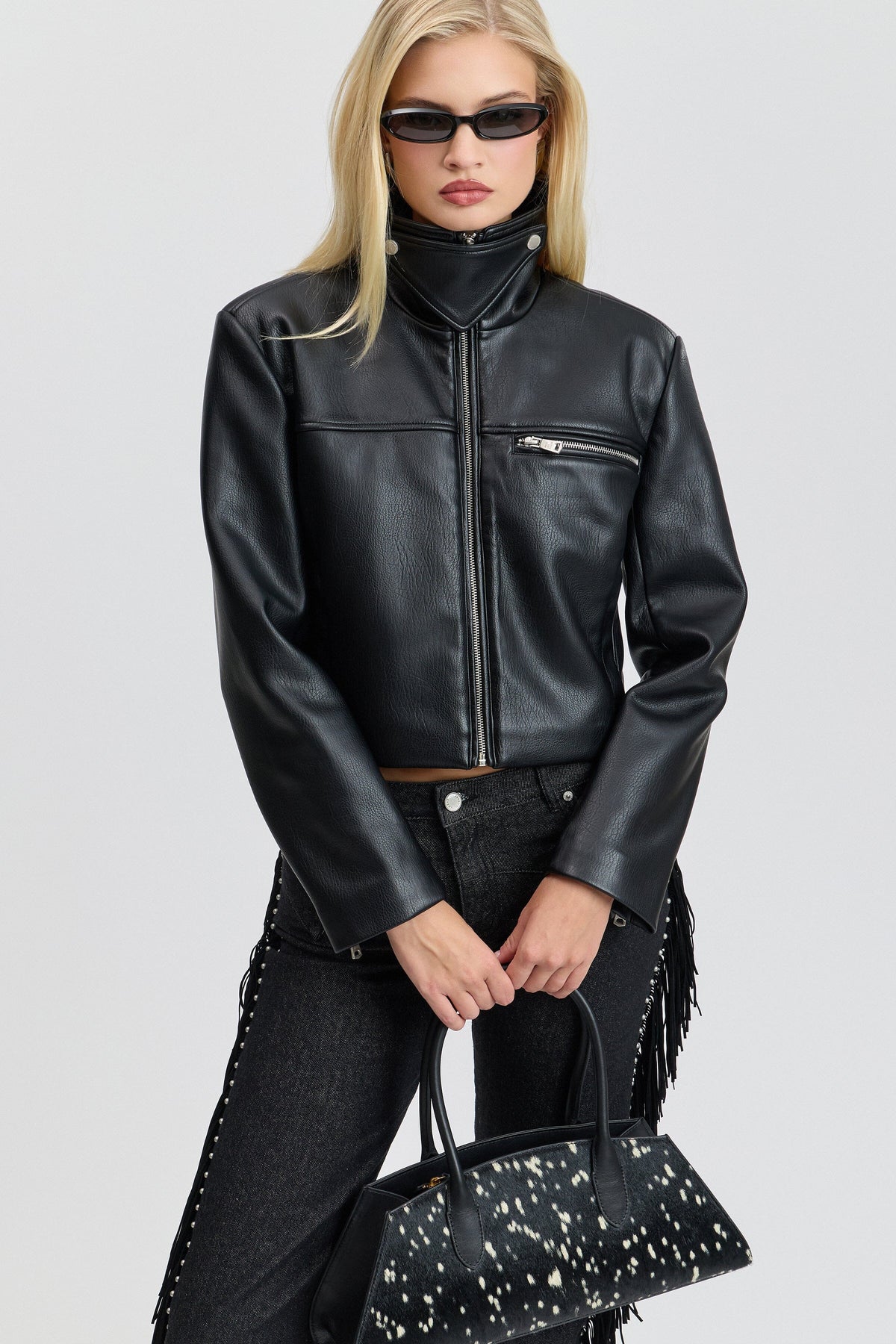 Strong-shoulder black leather cropped jacket with a high stand collar and a front zipper by Avec Les Filles.