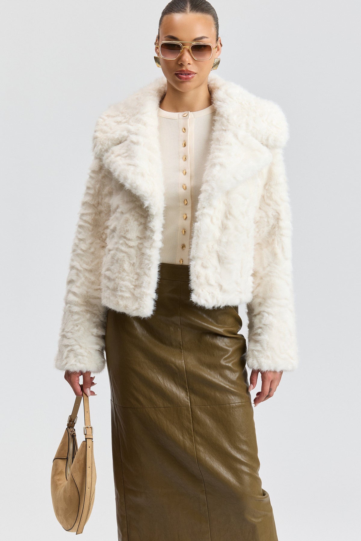 White fur jacket with a center-front and wide collar. Shop designer women's cute white fur jackets by Avec Les Filles.