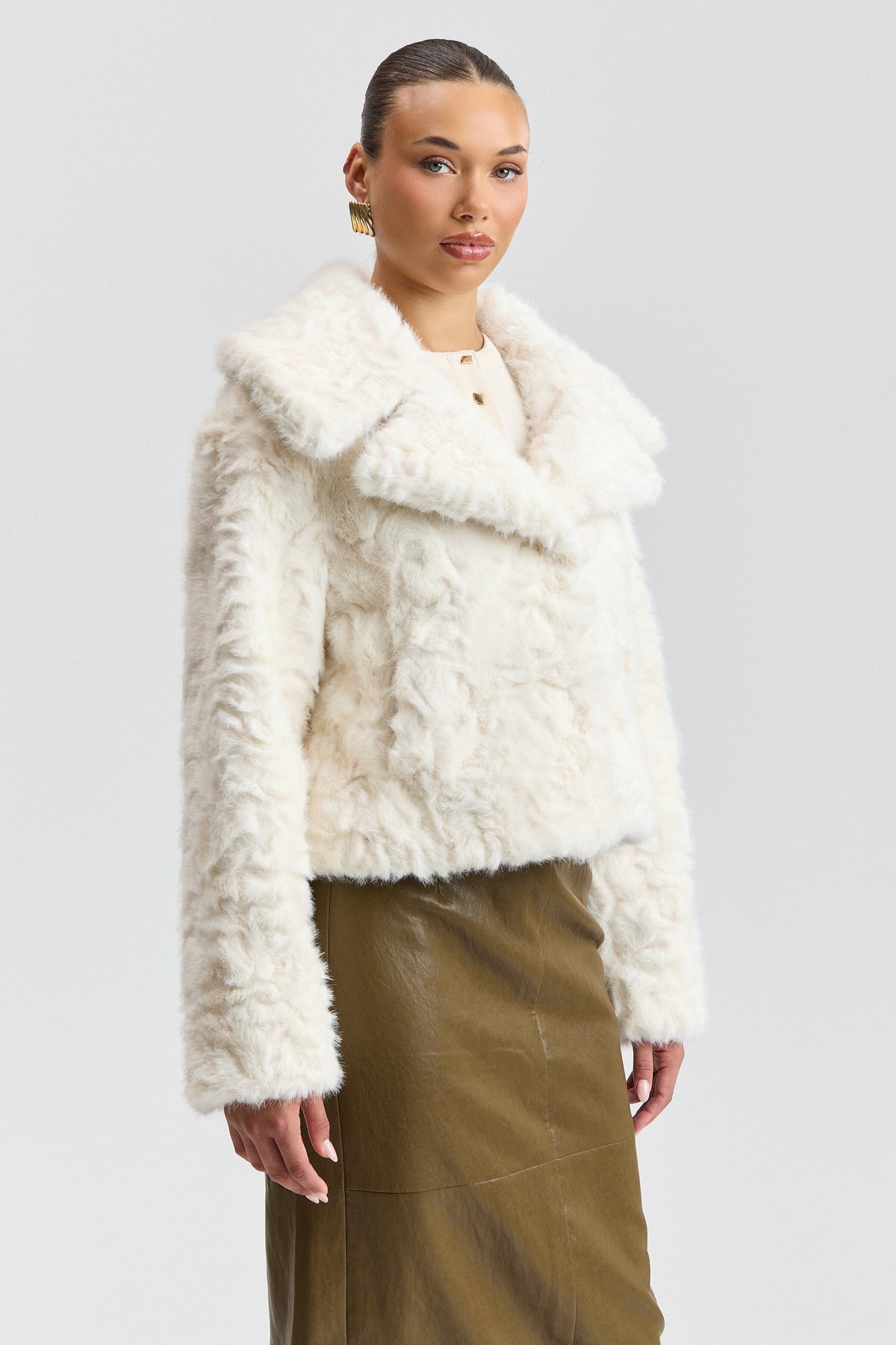 White winter jacket with a center-front and notched collar. Shop women's cute white fur jackets by Avec Les Filles.