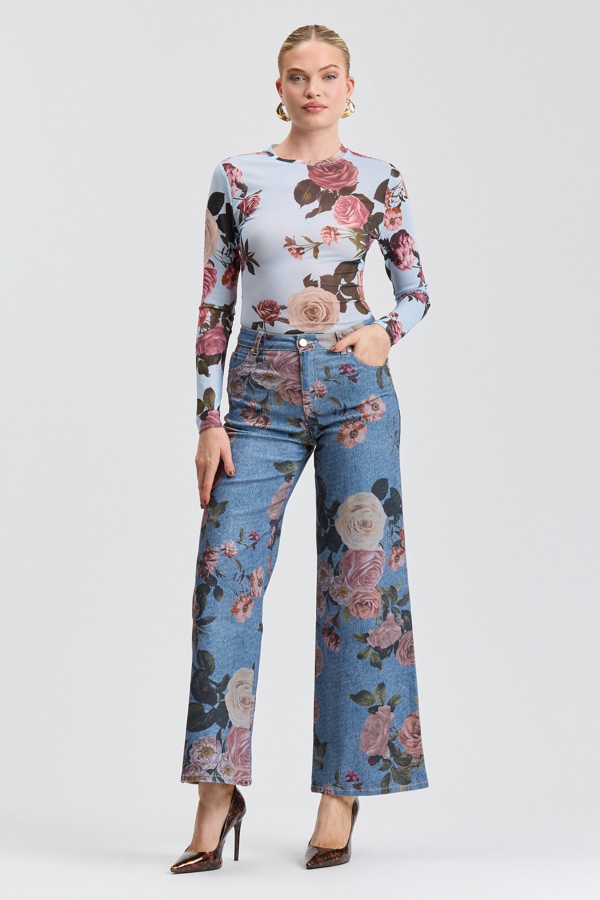 Blue denim floral jeans with a high-rise waist and pockets. Shop designer wide leg jeans women by Avec Les Filles.
