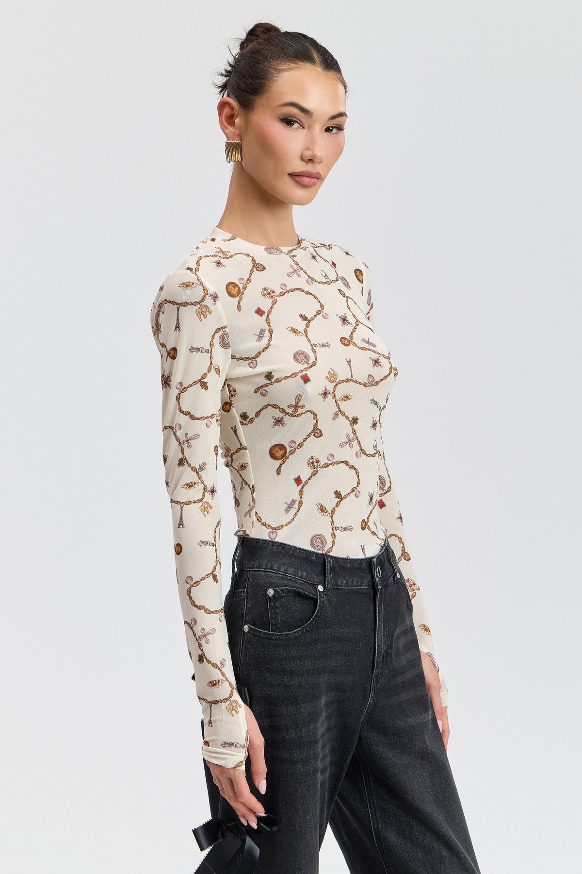 Cream flower top with a round neck and long fitted sleeves. Shop women's cute floral mesh tops by Avec Les Filles.