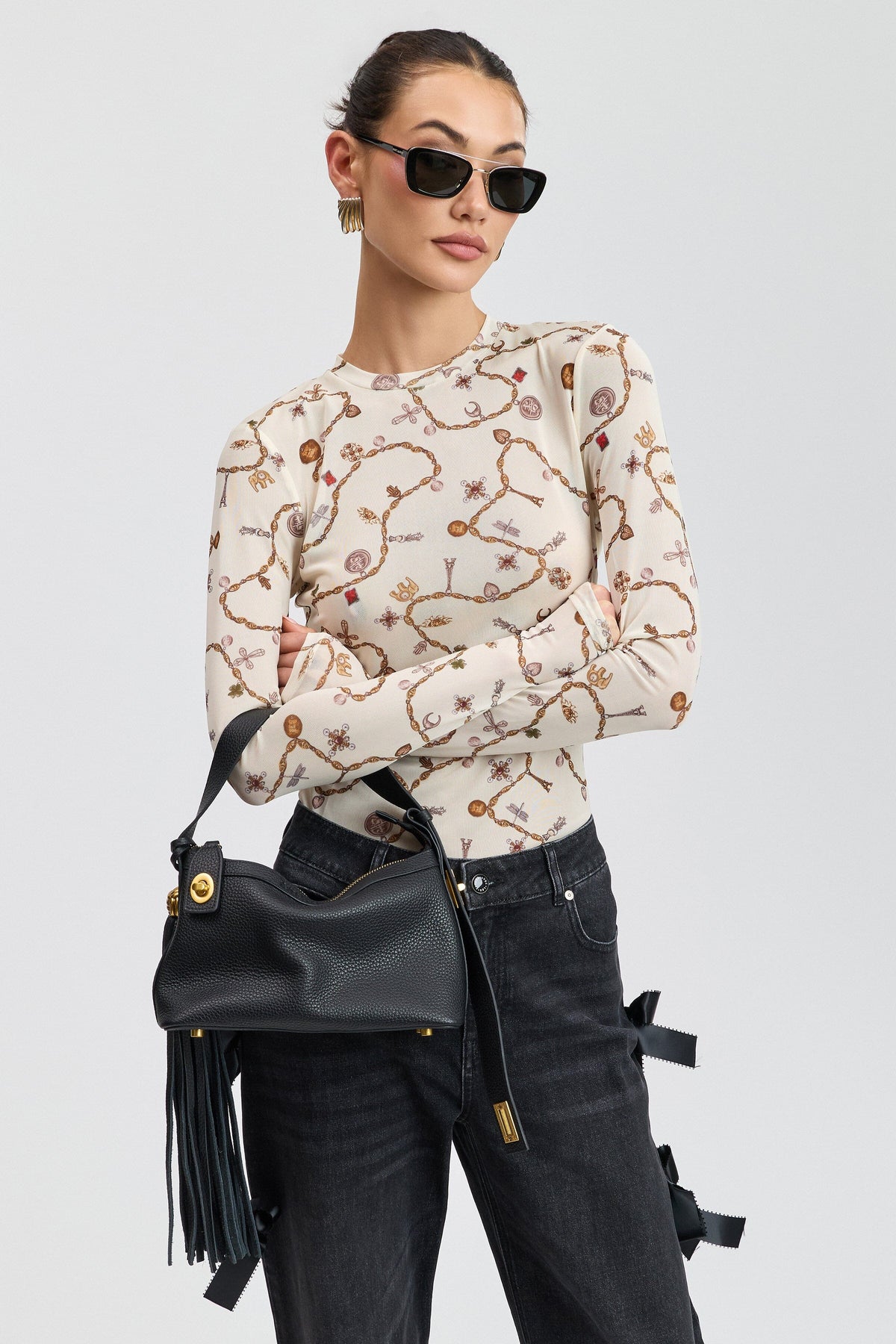 Cream printed floral top with round neck and long fitted sleeves. Shop women's floral mesh tops by Avec Les Filles.
