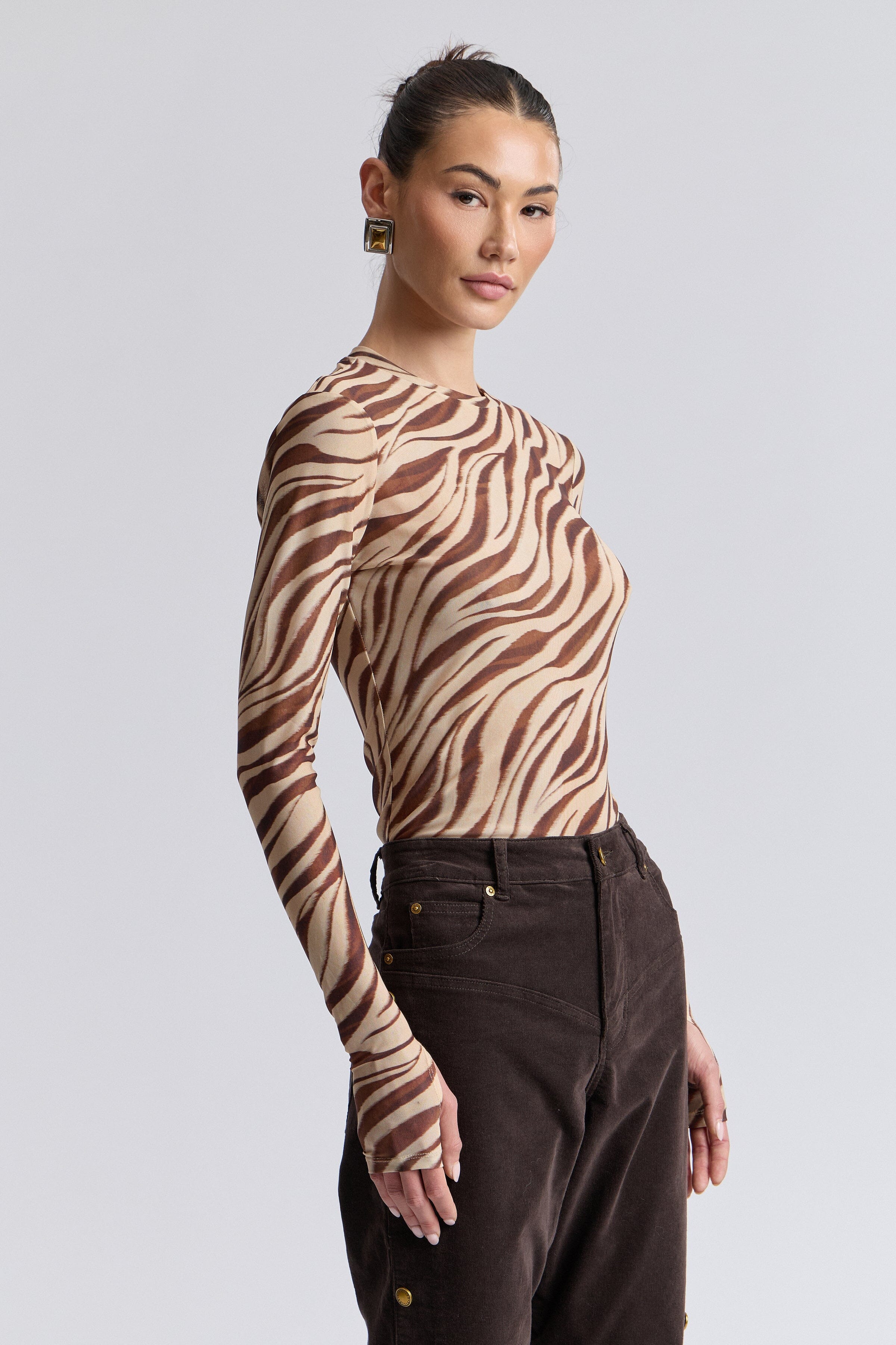 Zebra animal print sheer mesh long sleeve top with thumbhole sleeves. Shop women's printed tops by Avec Les Filles