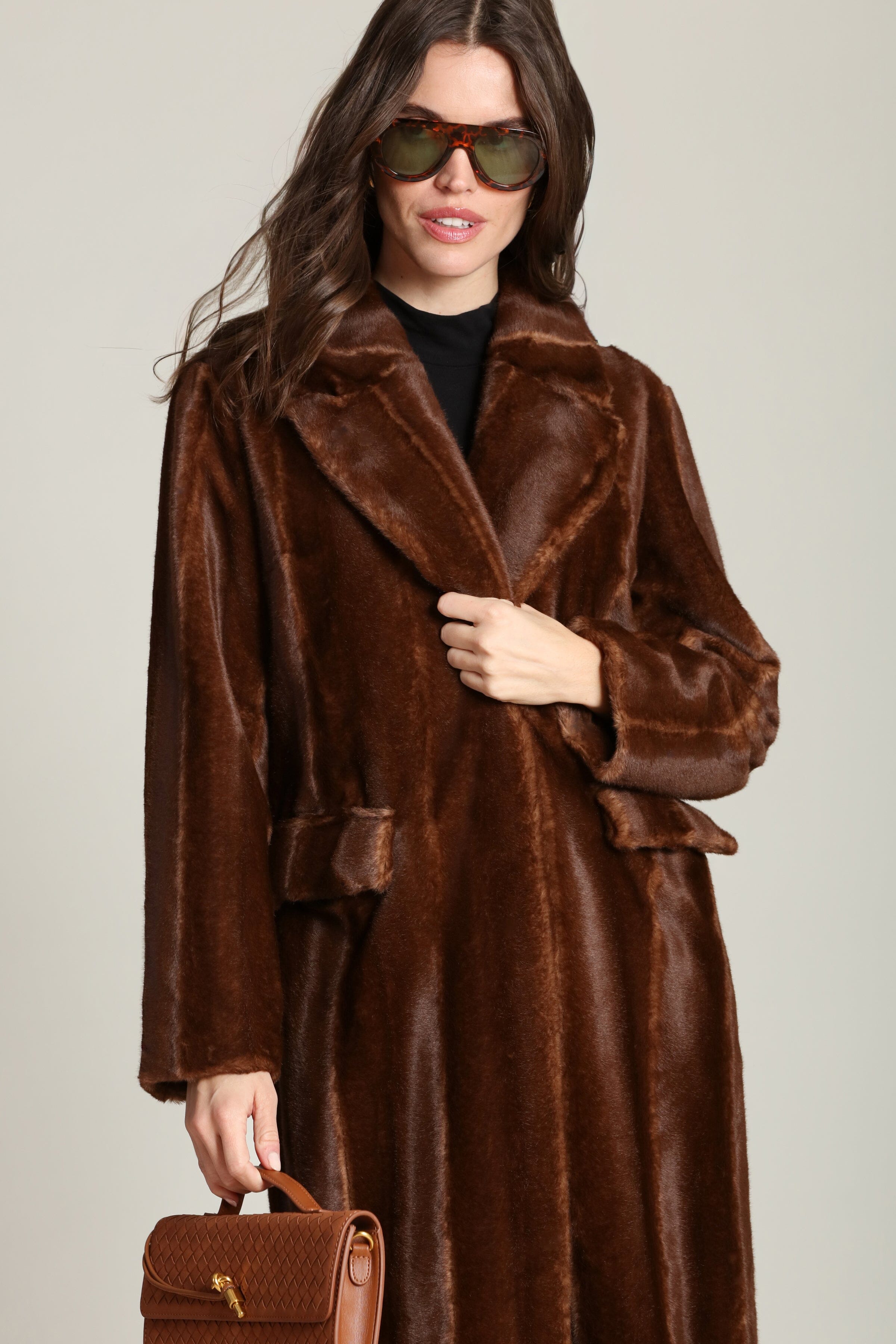 Striped faux mink fur brown button-front long coat with notched lapel collar and side flap pockets. Shop cute women's long fake fur coats by Avec Les Filles.