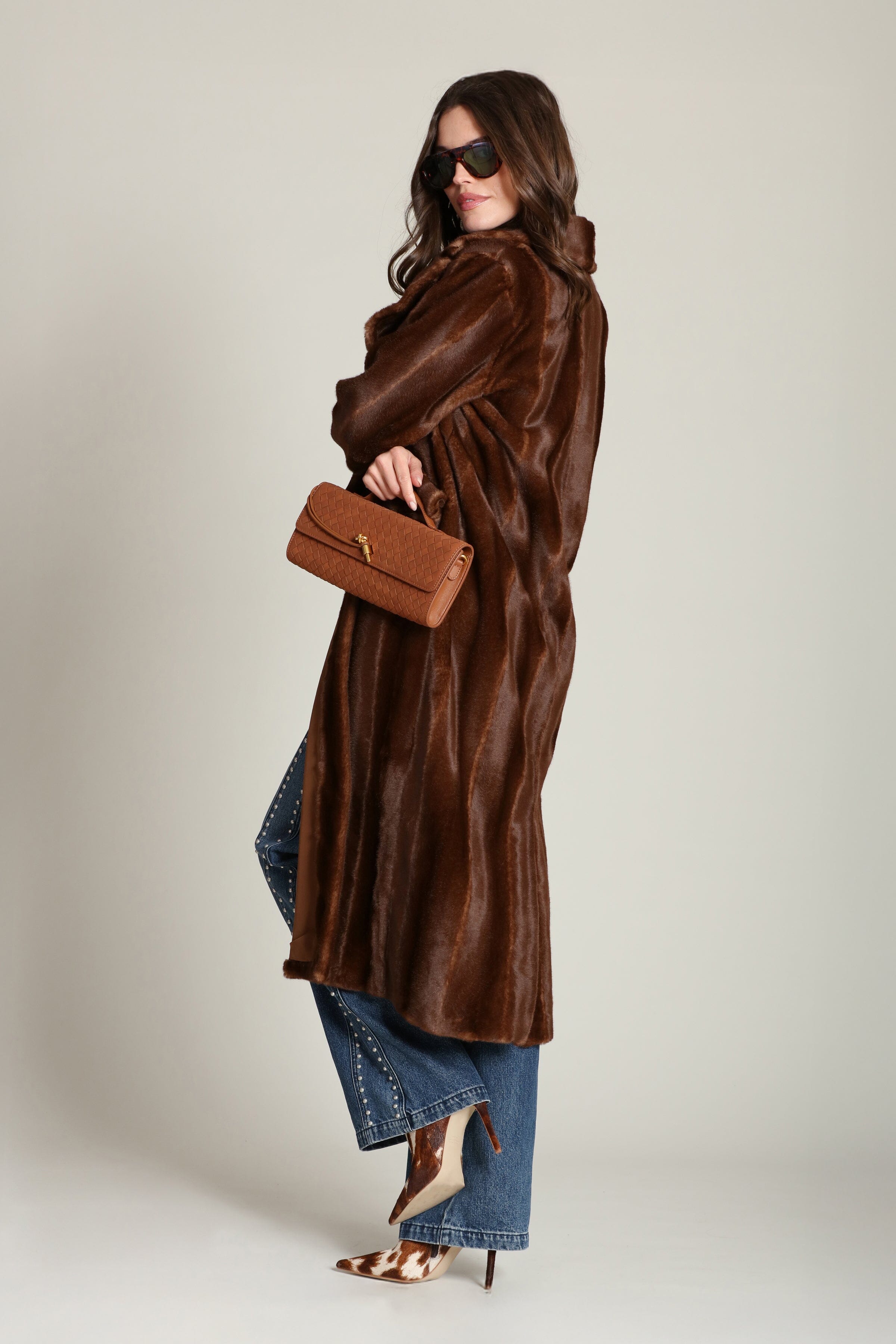 Striped faux mink fur brown button-front long coat with notched lapel collar and side flap pockets. Shop cute women's long fake fur coats by Avec Les Filles.