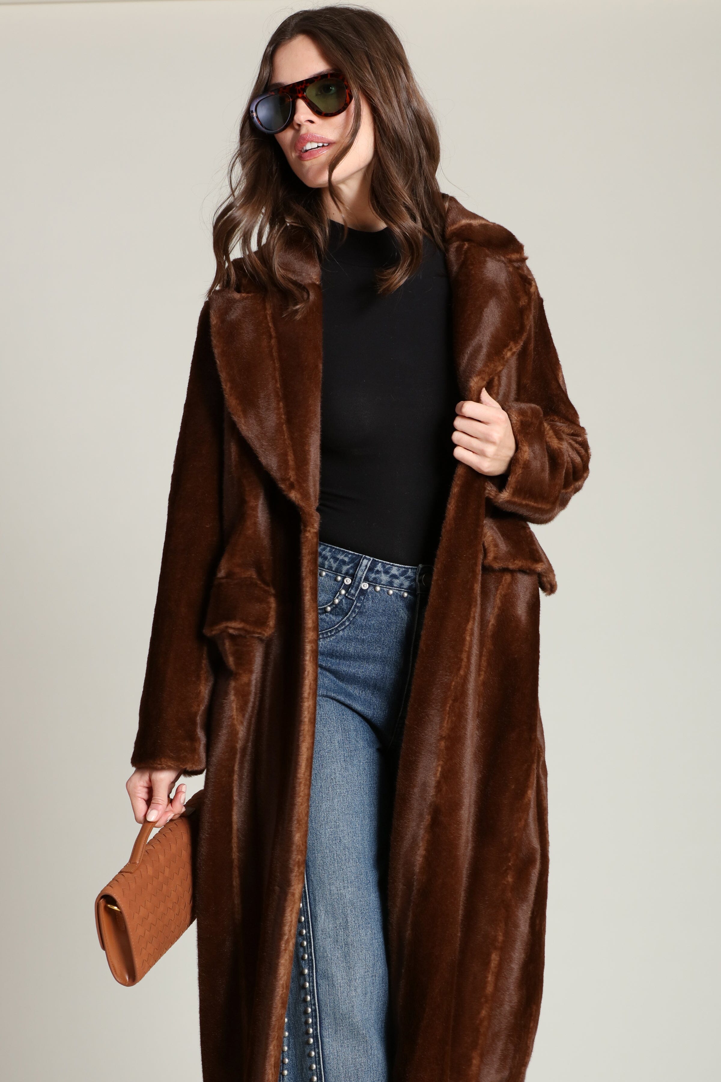 Striped faux mink fur brown button-front long coat with notched lapel collar and side flap pockets. Shop cute women's long fake fur coats by Avec Les Filles.