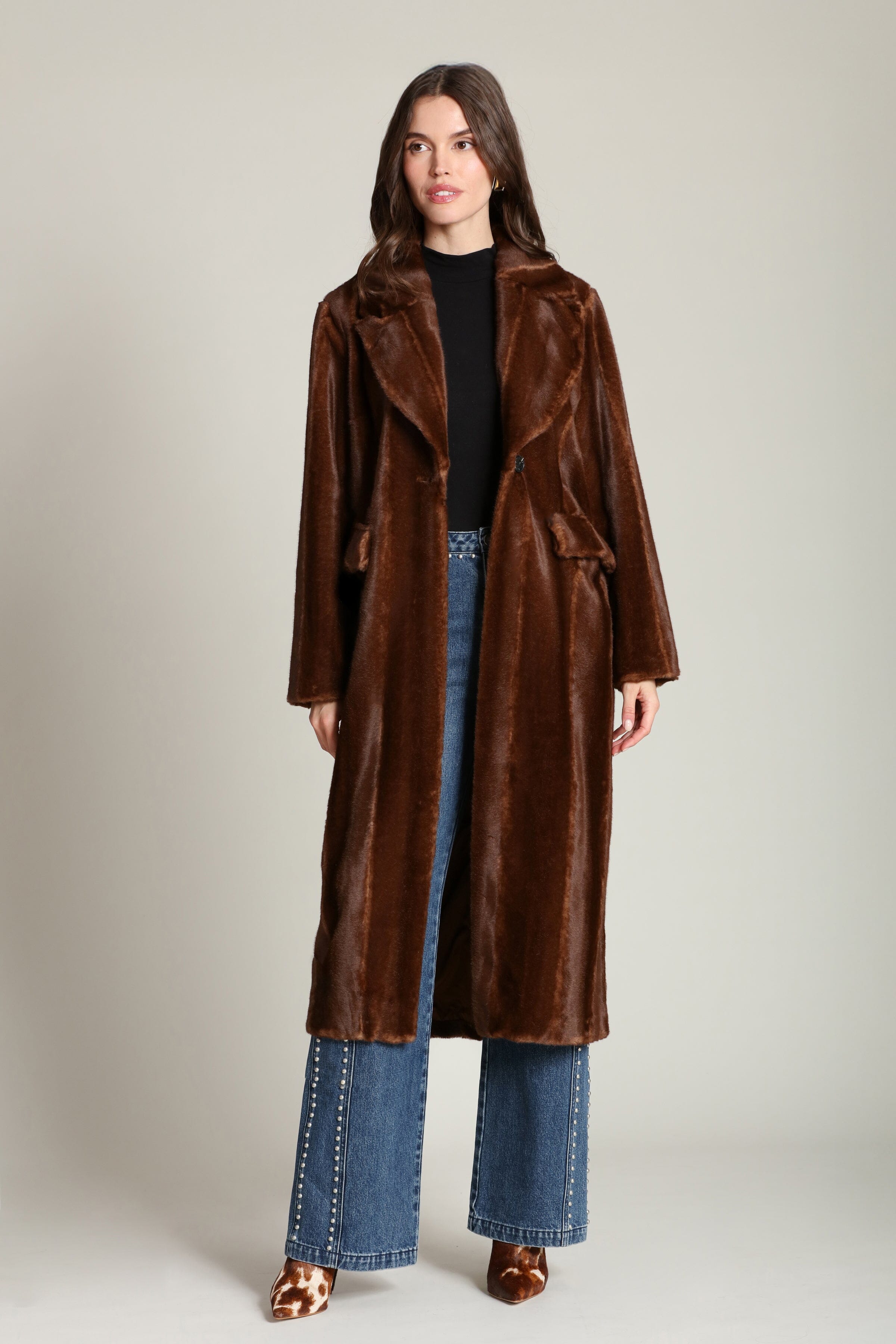 Striped faux mink fur brown button-front long coat with notched lapel collar and side flap pockets. Shop cute women's long fake fur coats by Avec Les Filles.