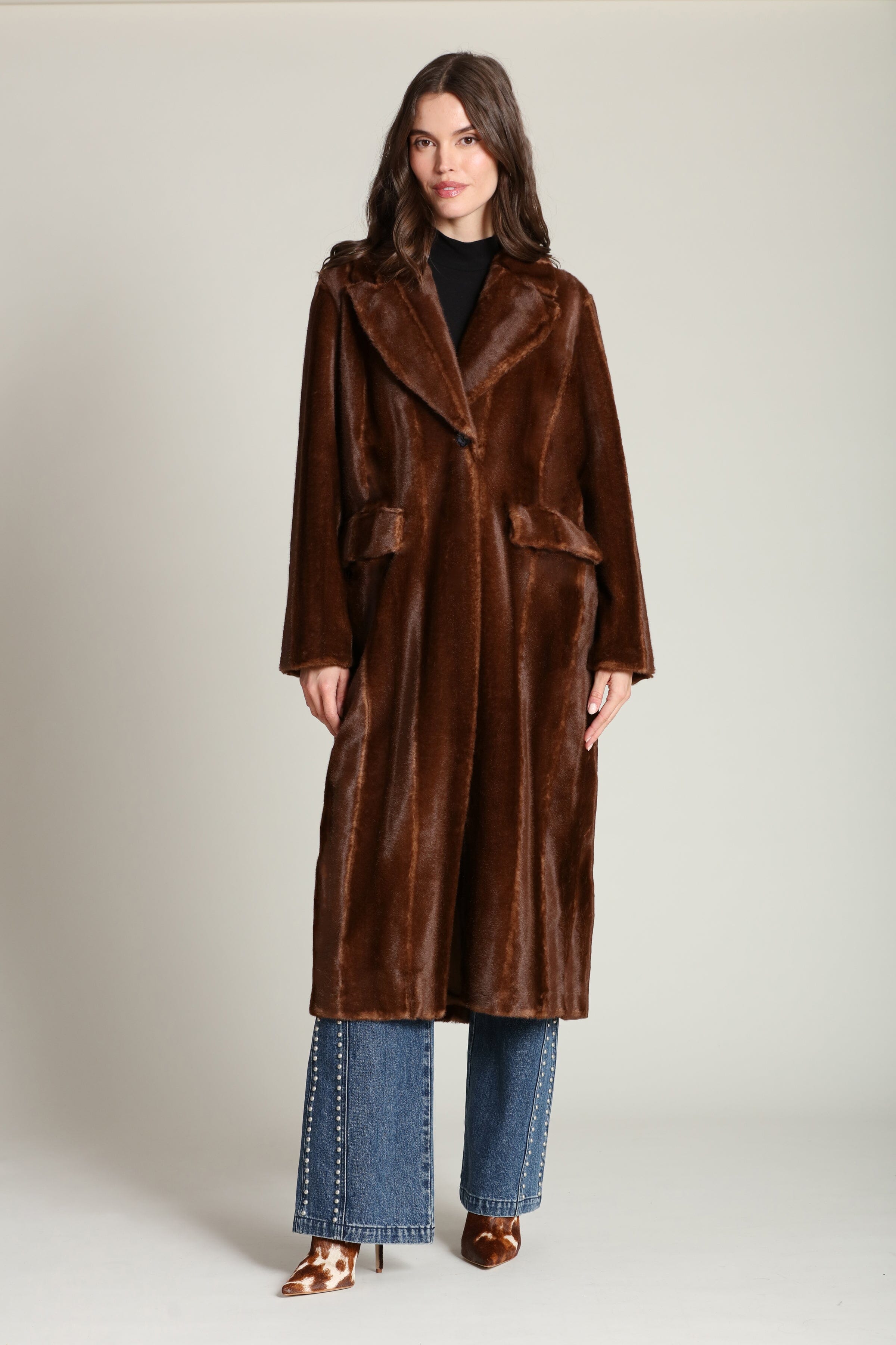 Striped faux mink fur brown button-front long coat with notched lapel collar and side flap pockets. Shop cute women's long fake fur coats by Avec Les Filles.