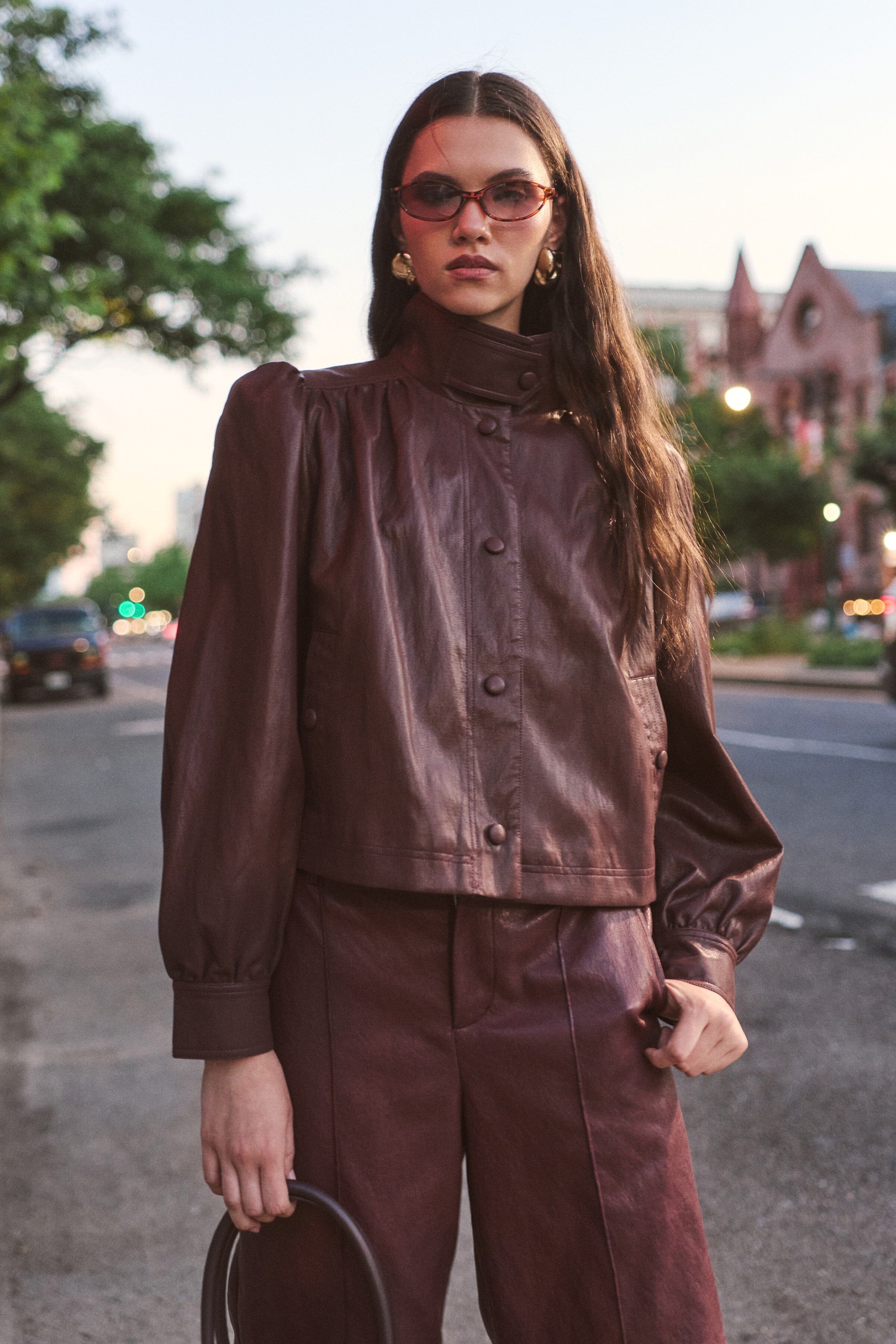 Puff-sleeve brown jacket faux leather with stand collar and welt pockets. Shop cute cropped jackets by Avec Les Filles.