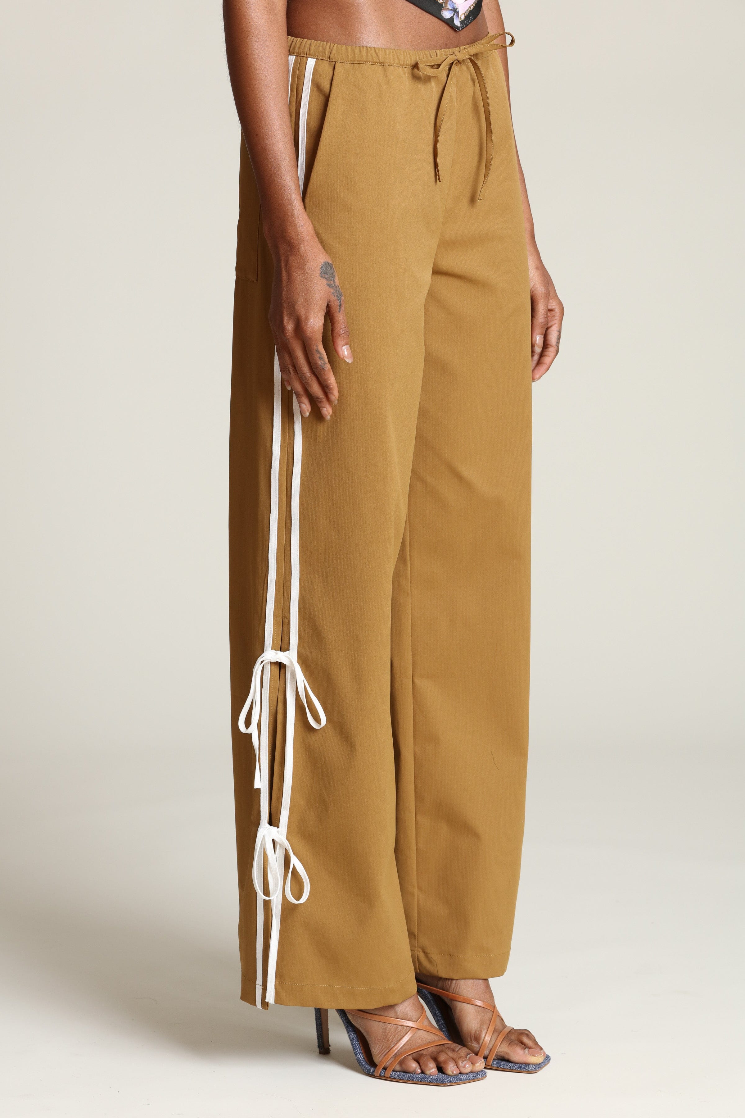 Side tie brown wide leg track pants with side slits and adjustable drawstring by Avec Les Filles