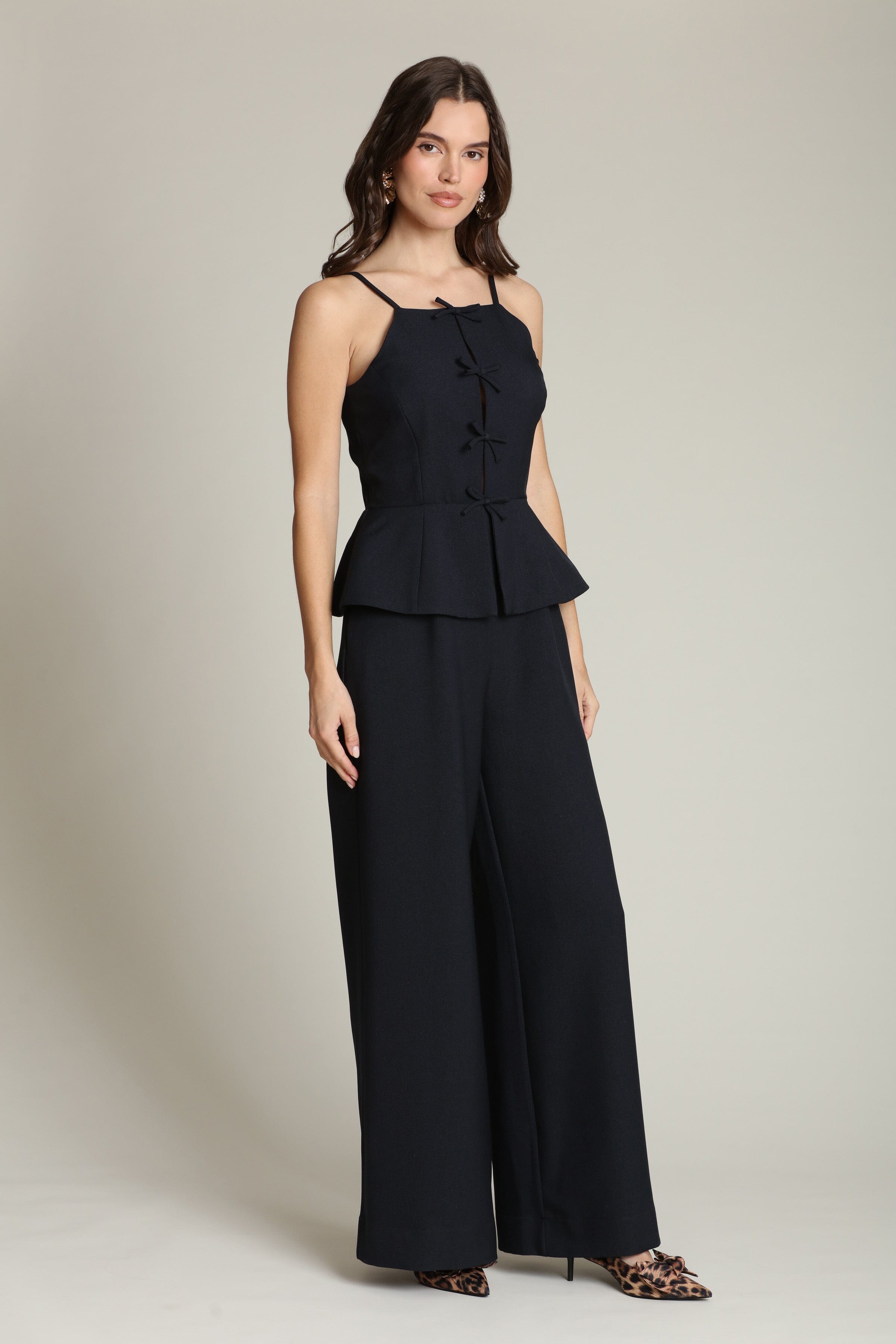 Peplum wide-leg navy jumpsuit with adjustable spaghetti straps and a front tie-front by Avec Les Filles