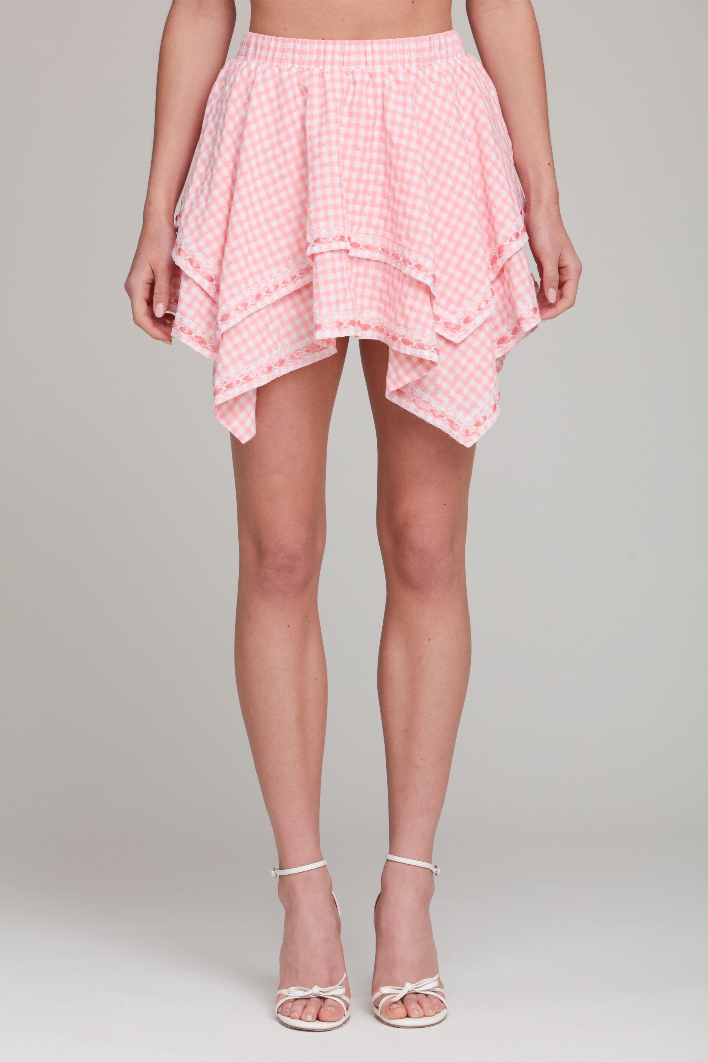 Gingham pink mini skirt with an elastic waistband and handkerchief hem by Avec Les Filles