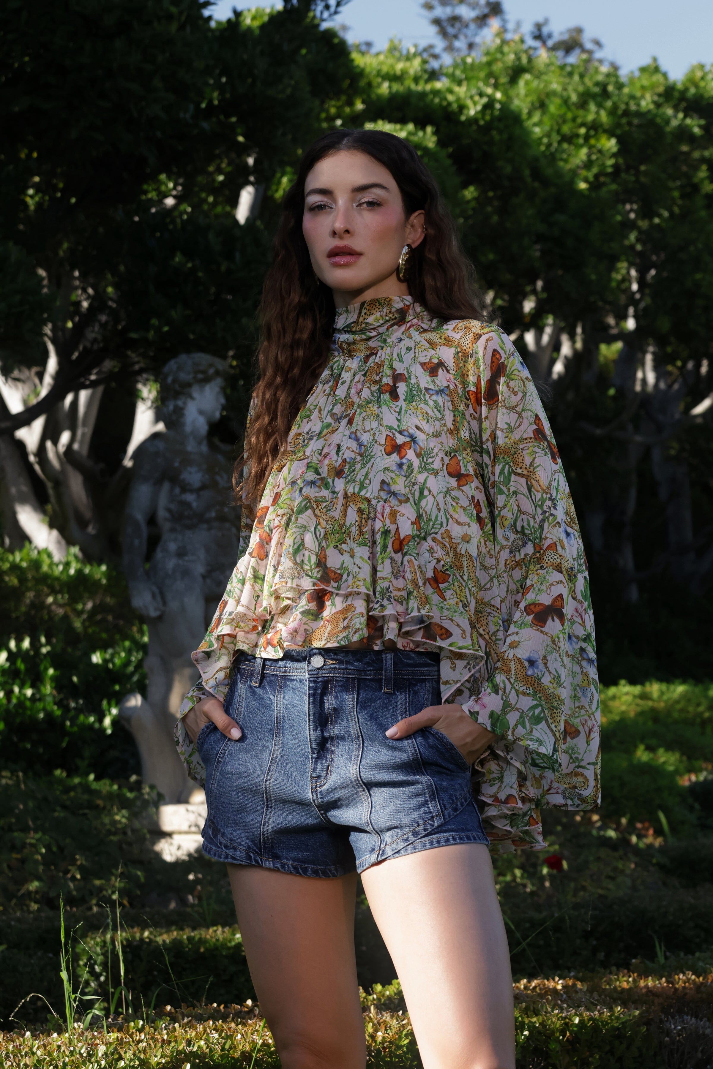 Pink cheetah print chiffon ruffle blouse top with dark blue high-rise denim shorts by Avec Les Filles
