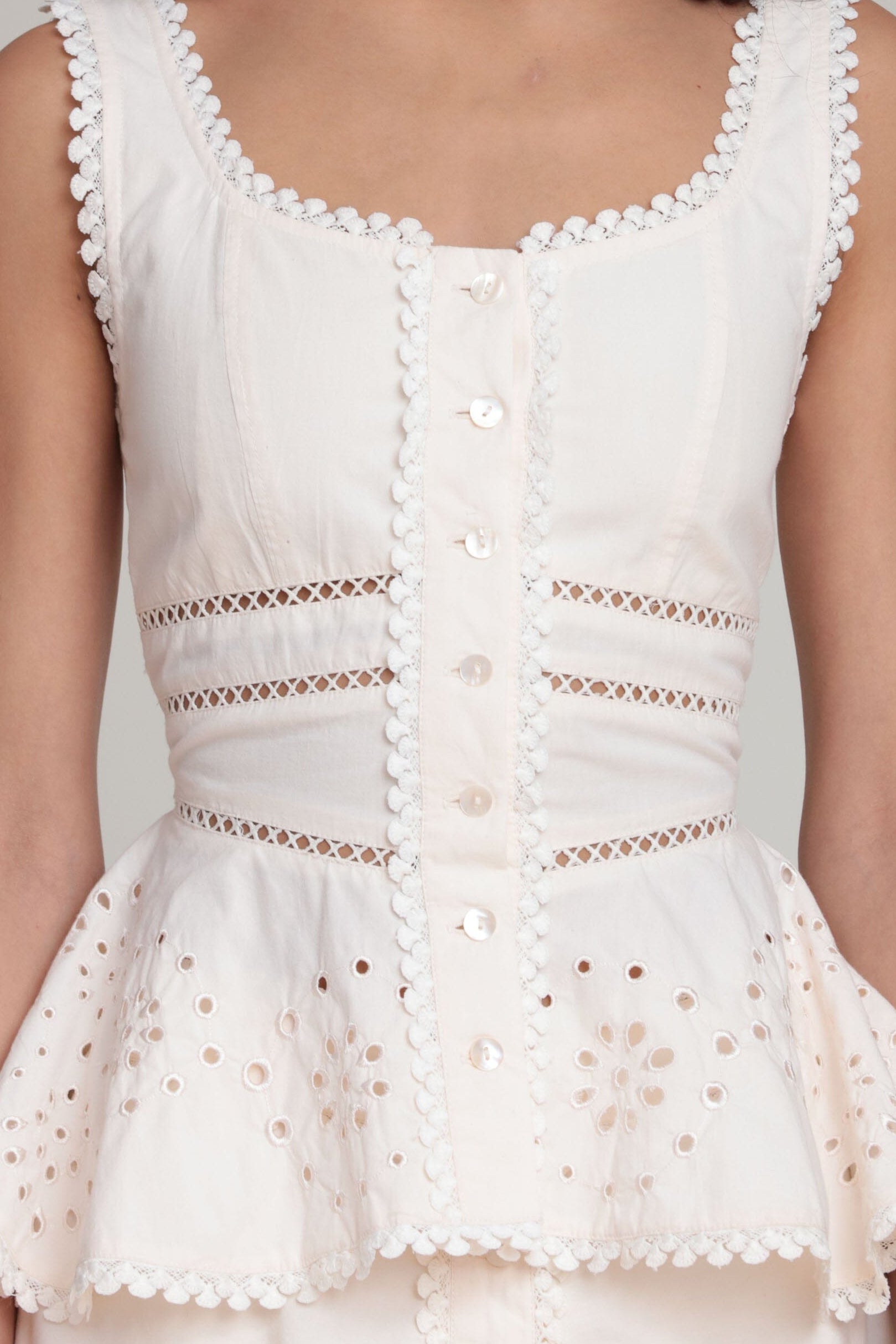 cotton embroidered sleeveless white peplum top with a scoop neckline by Avec Les Filles