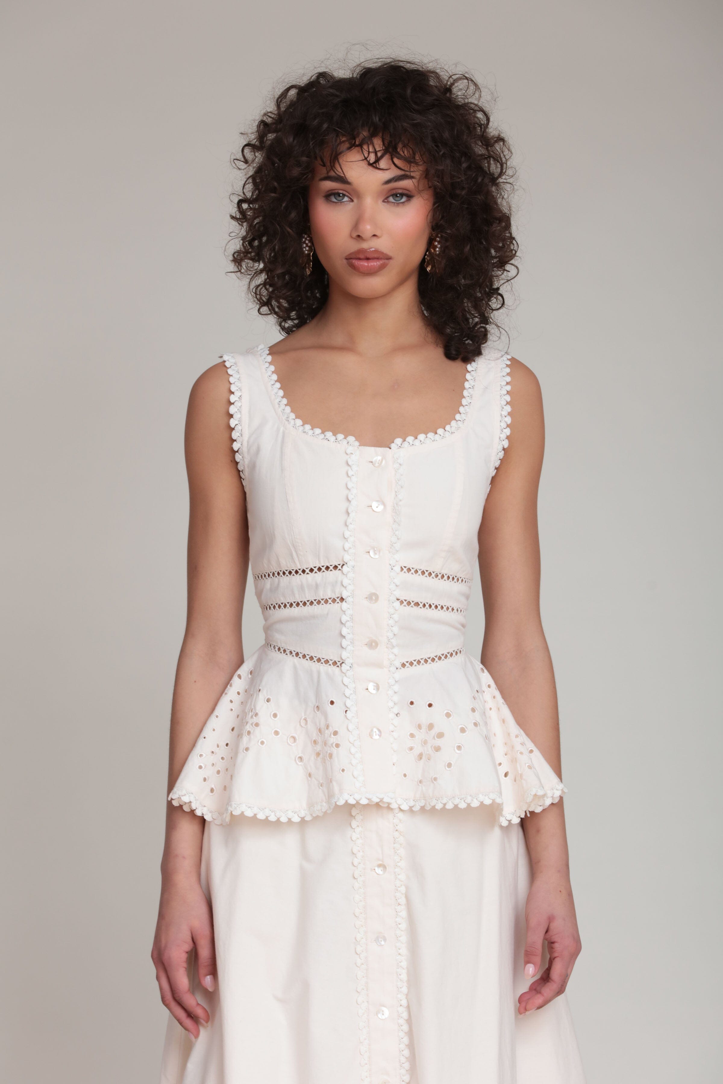 cotton embroidered cream sleeveless peplum tank top with a scoop neckline by Avec Les Filles