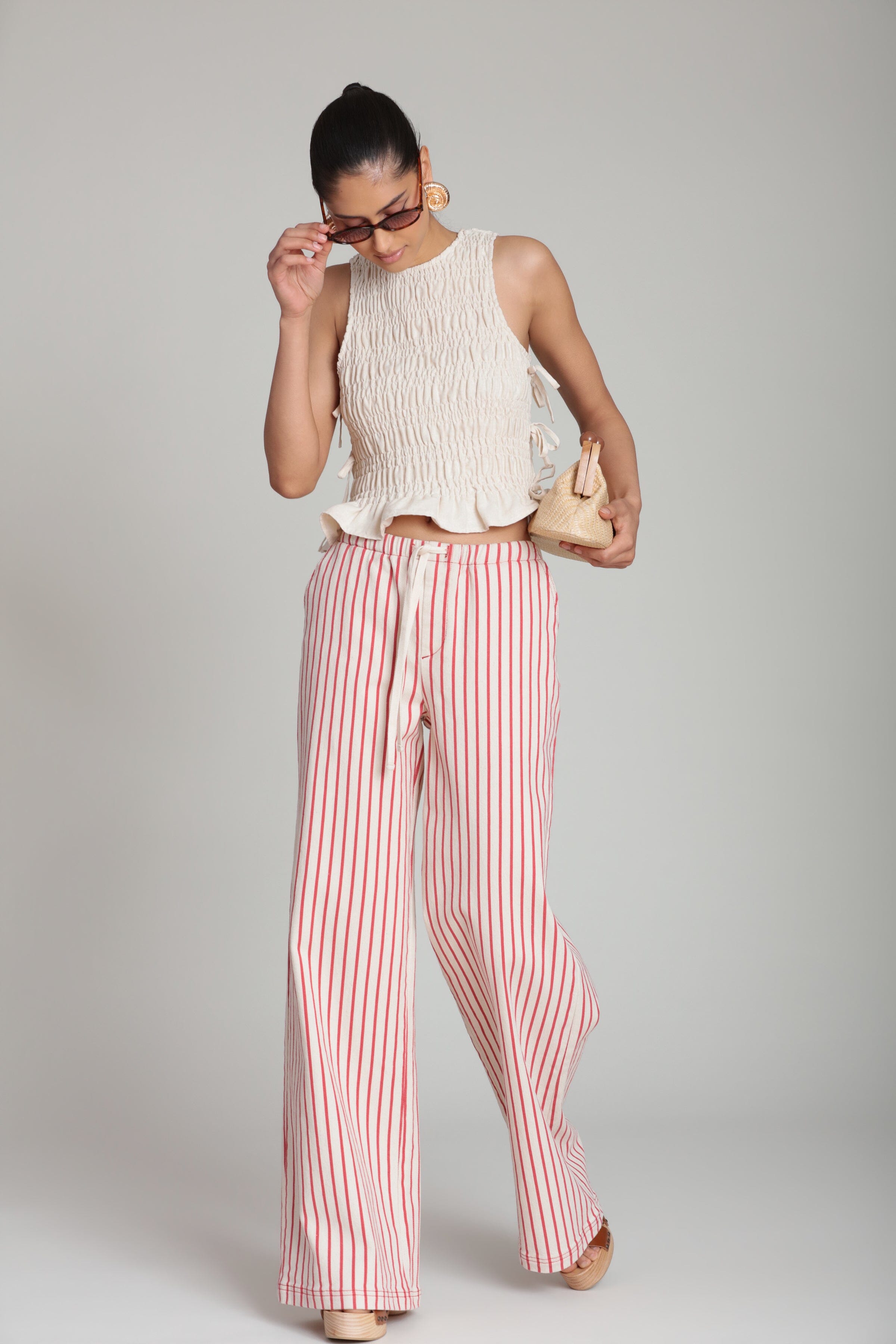 Linen blend side-tie sleeveless cream ruffle top with red cotton striped pants by Avec Les Filles.