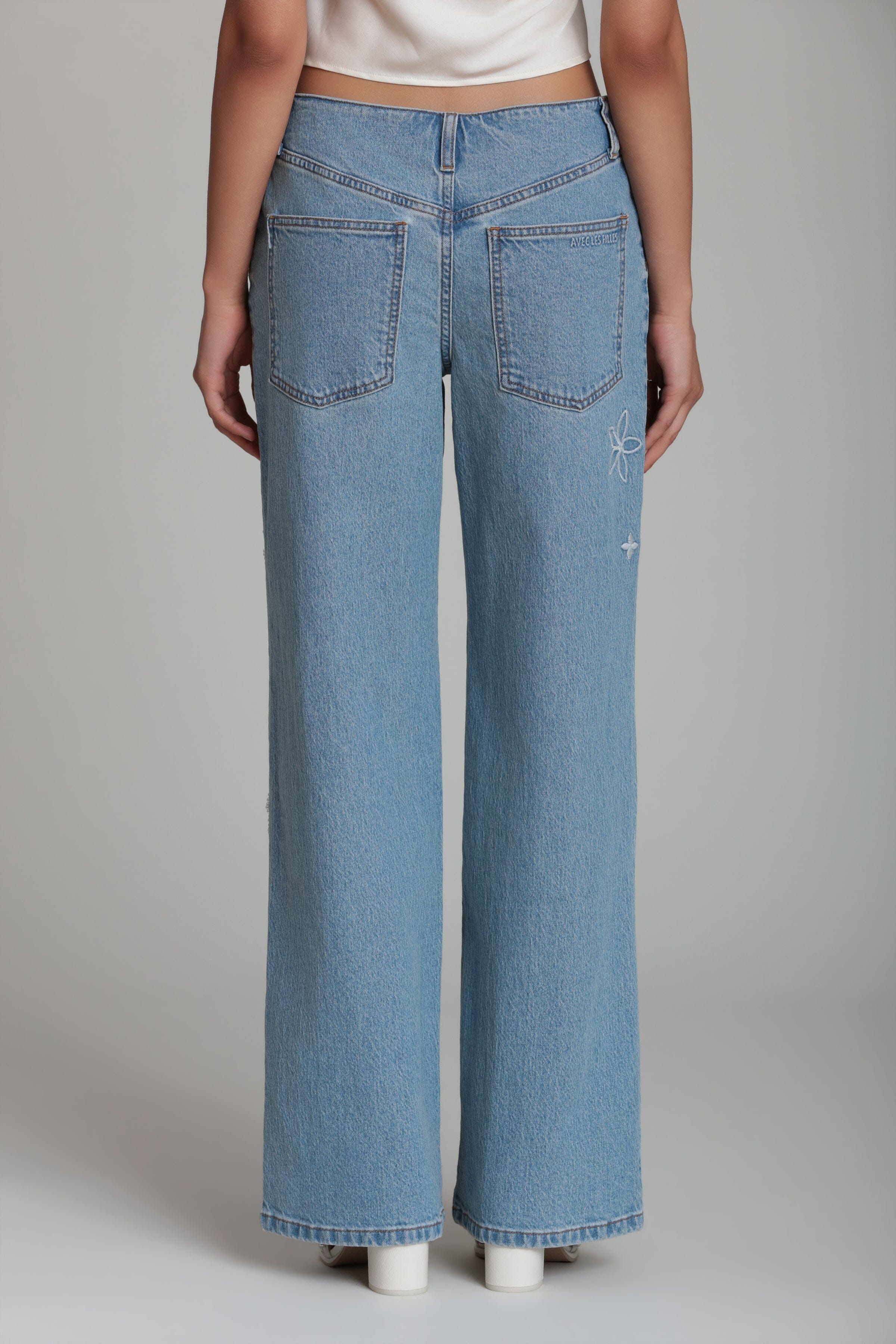 Light wash wide leg jeans with a mid-rise and pockets - Shop designer embroidered denim jeans for women by Avec Les Filles
