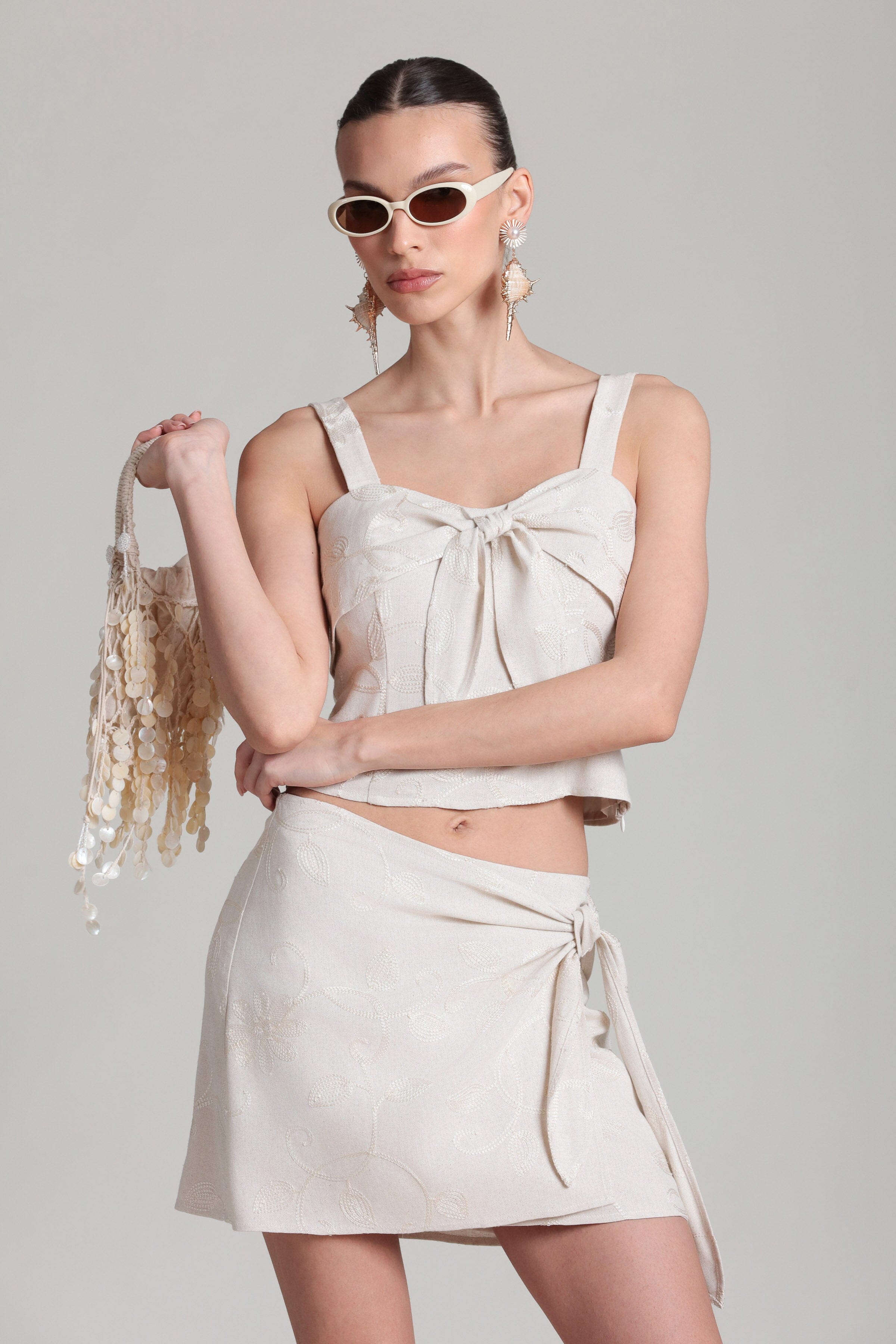 Embroidered cream linen wrap skirt. Shop designer women's cute mini skirts by Avec Les Filles.