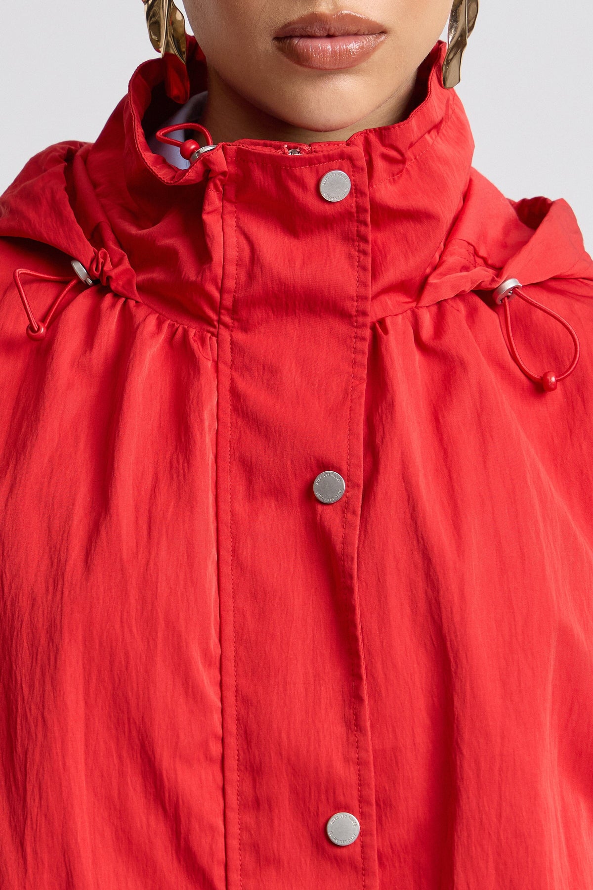 Nylon hooded womens windbreaker red jacket with balloon sleeves. Shop cute red jackets by Avec Les Filles.