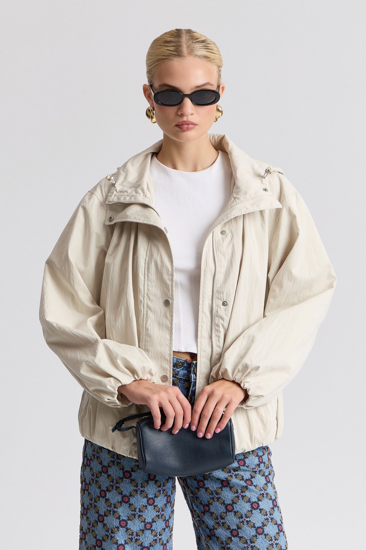 Nylon-blend hooded white windbreaker jacket with balloon sleeves. Shop cute white jackets by Avec Les Filles.