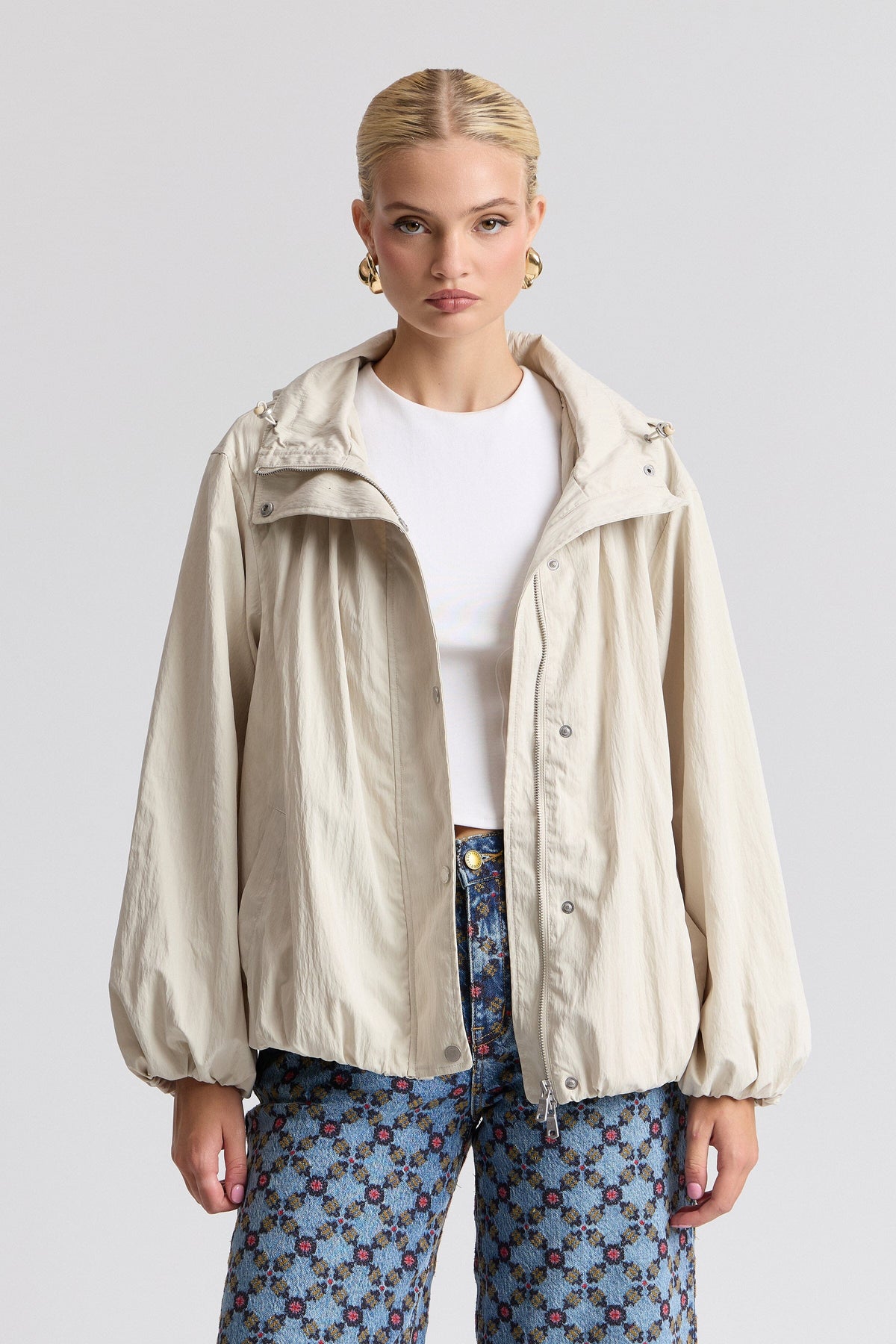 Nylon-blend hooded white windbreaker jacket with balloon sleeves. Shop women's jackets by Avec Les Filles.