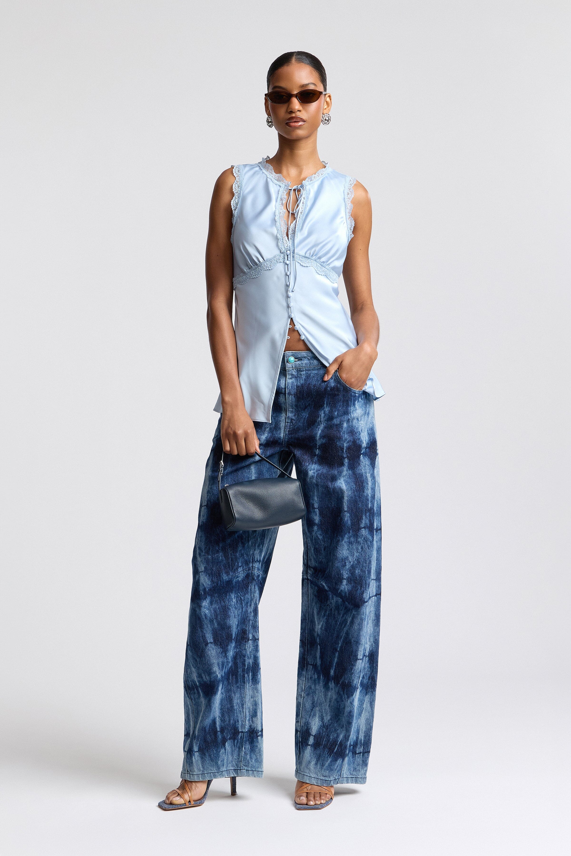 Satin blouse blue with an empire waist and an adjustable tie - Shop designer women's cute sleeveless tops by Avec Les Filles.